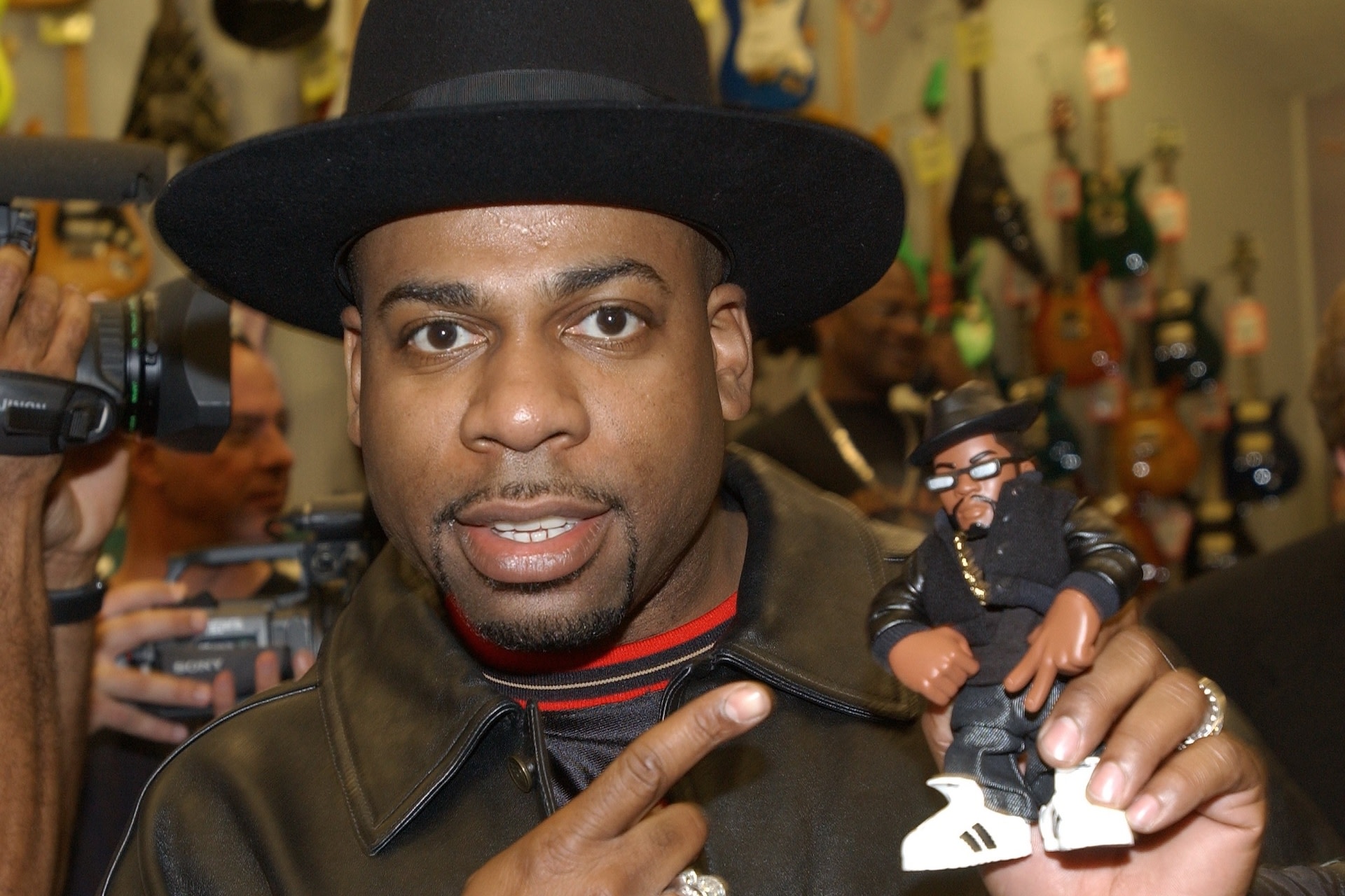 (FILE PHOTO) Musical artist Jason "Jam Master Jay" Mizell holds a toy figure of himself at a ceremony honoring his hip-hop group RUN-DMC's induction into the Hollywood RockWalk February 25, 2002 at the Guitar Center in Hollywood, California. Mizell was shot and killed inside a Queens, New York studio October 30, 2002, according to a group representive. Police, who say two unidentified men were shot around 7:30 p.m. local time, have confirmed that one man was dead on arrival at a local hospital. 