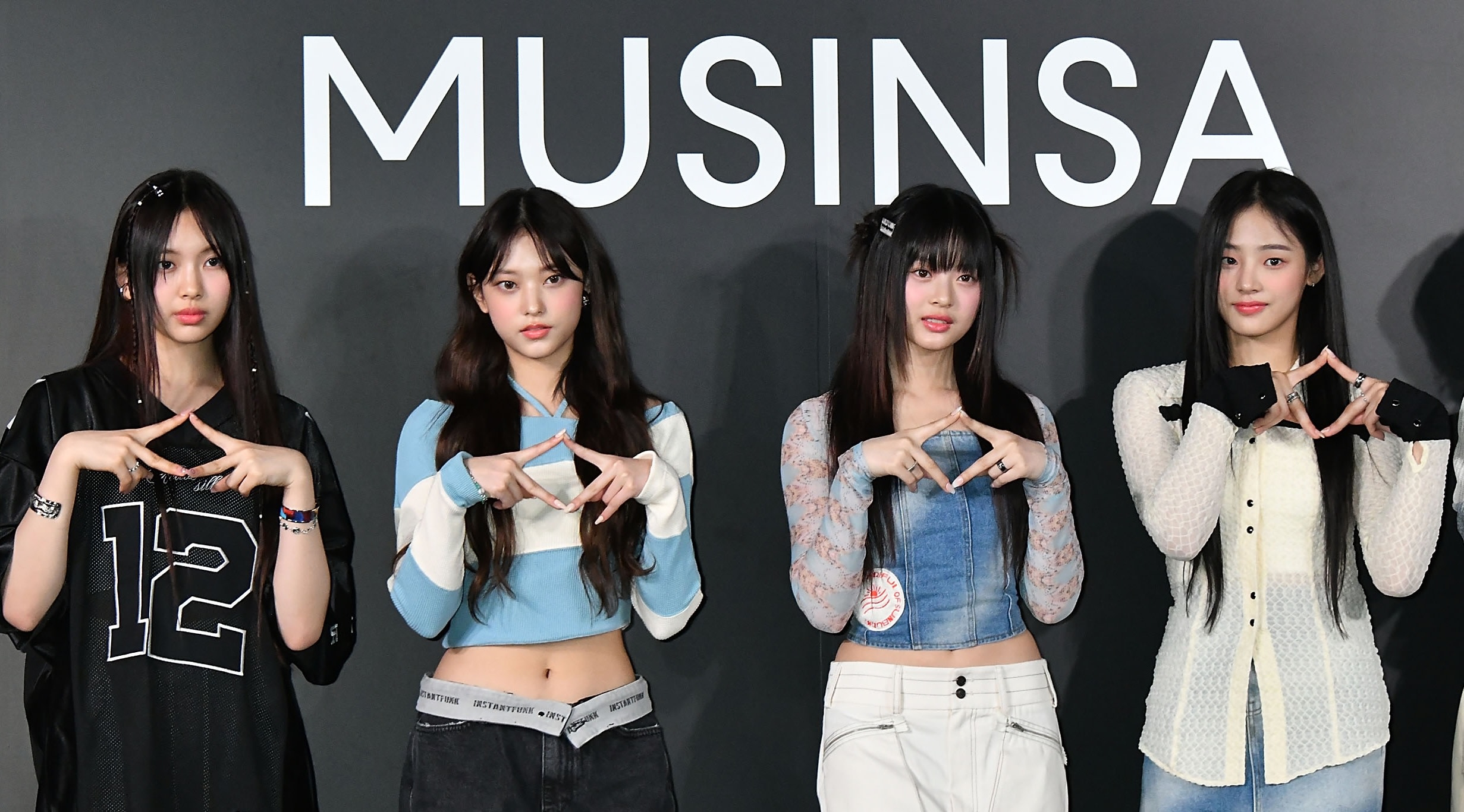 (L-R) HYEIN, HAERIN, HANNI, and MINJI of K-pop group NewJeans attend the photocall for MUSINSA Pop-up Store Opening Ceremony on April 6, 2023 in Tokyo, Japan. 