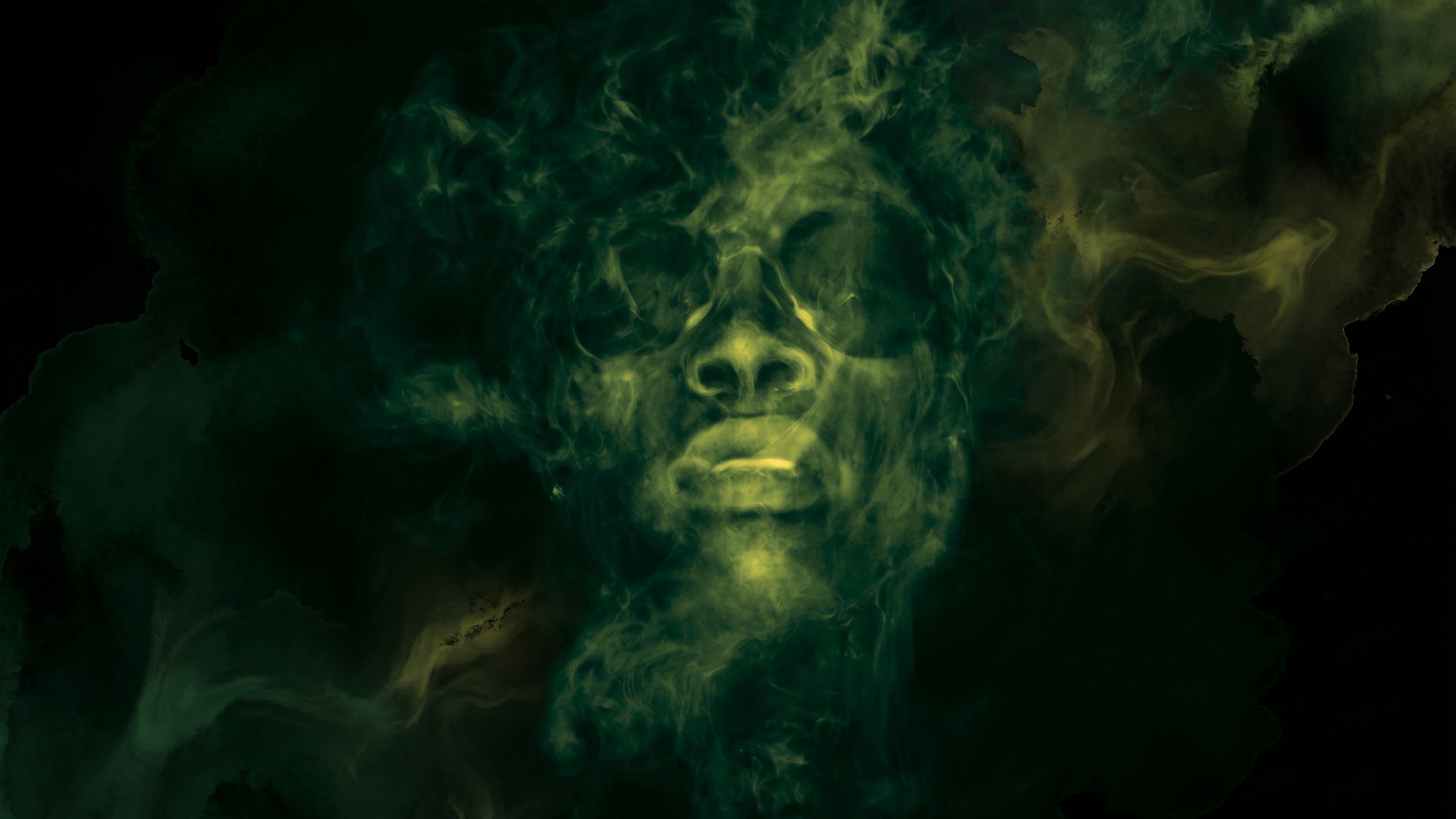 A person's face, wearing sunglasses, emerges from swirling green smoke in a mysterious and artistic composition.