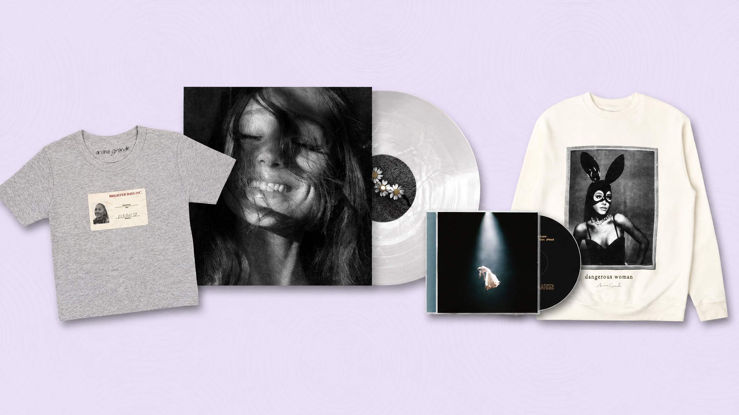 A collection of Ariana Grande merchandise, including a gray T-shirt, a vinyl record, a CD, and a white sweatshirt featuring her image.