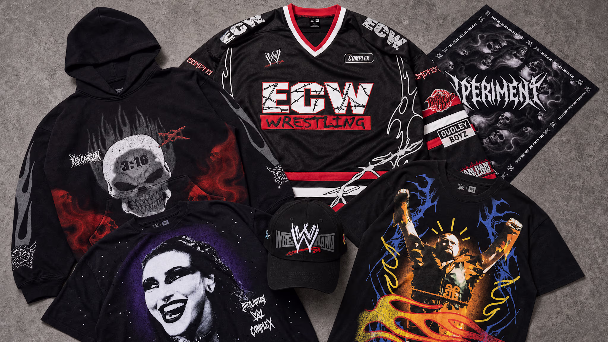 A collection of WWE-themed apparel, including a hoodie with a skull design, ECW wrestling jersey, graphic tees, and a WWE cap.