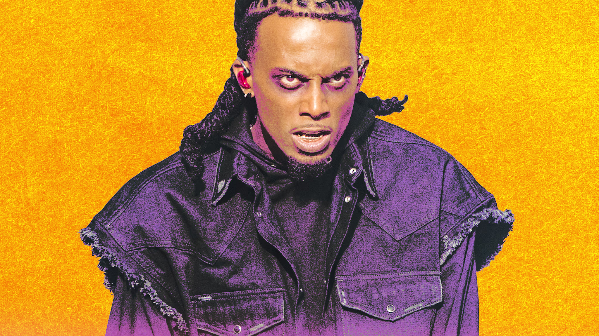 Playboi Carti wearing a dark jacket, poses against a vibrant orange background. He has created some of the best rap songs of the last 10 years. 