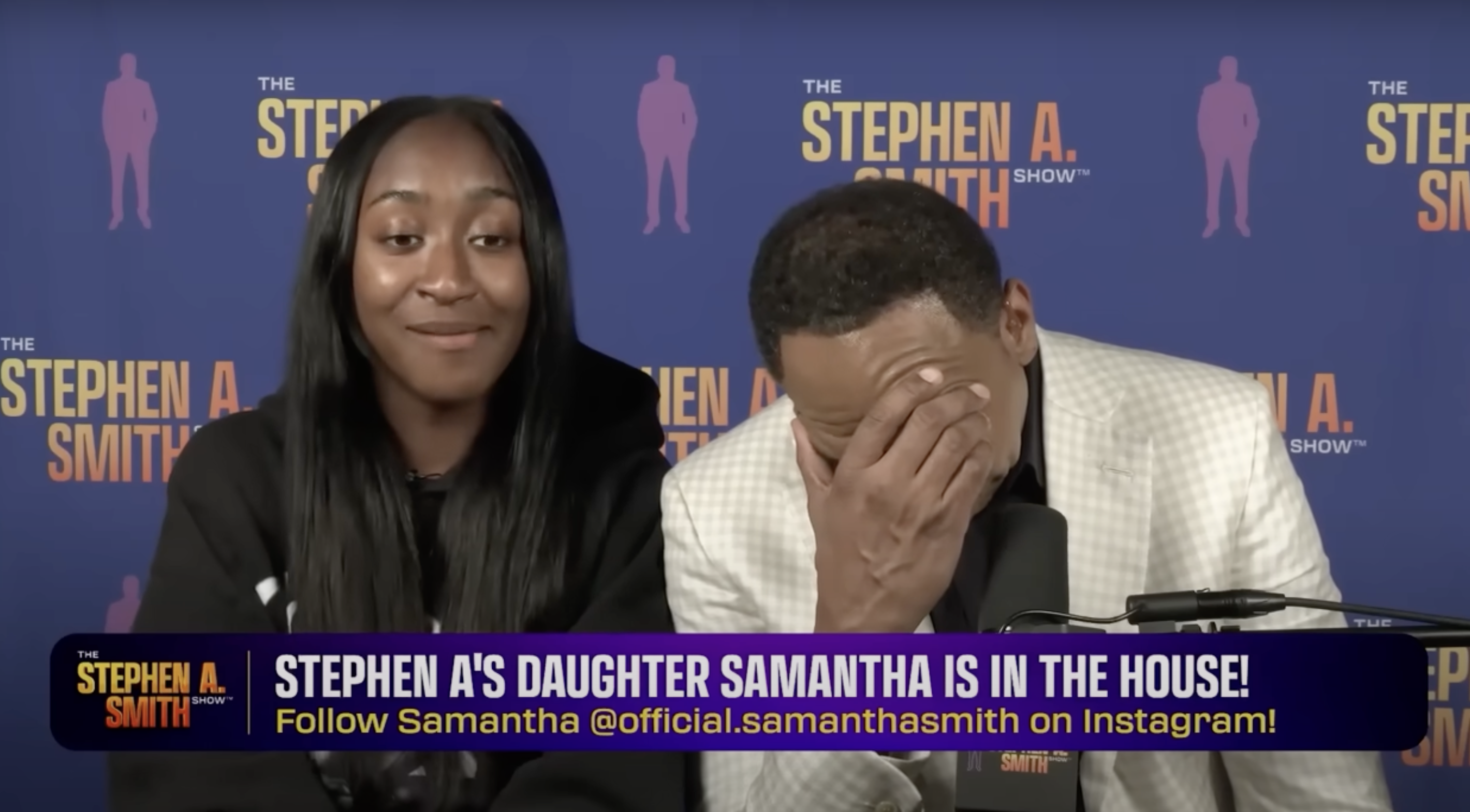 A woman and Stephen A. Smith, wearing a white jacket, are speaking into microphones on "The Stephen A. Smith Show" set.
