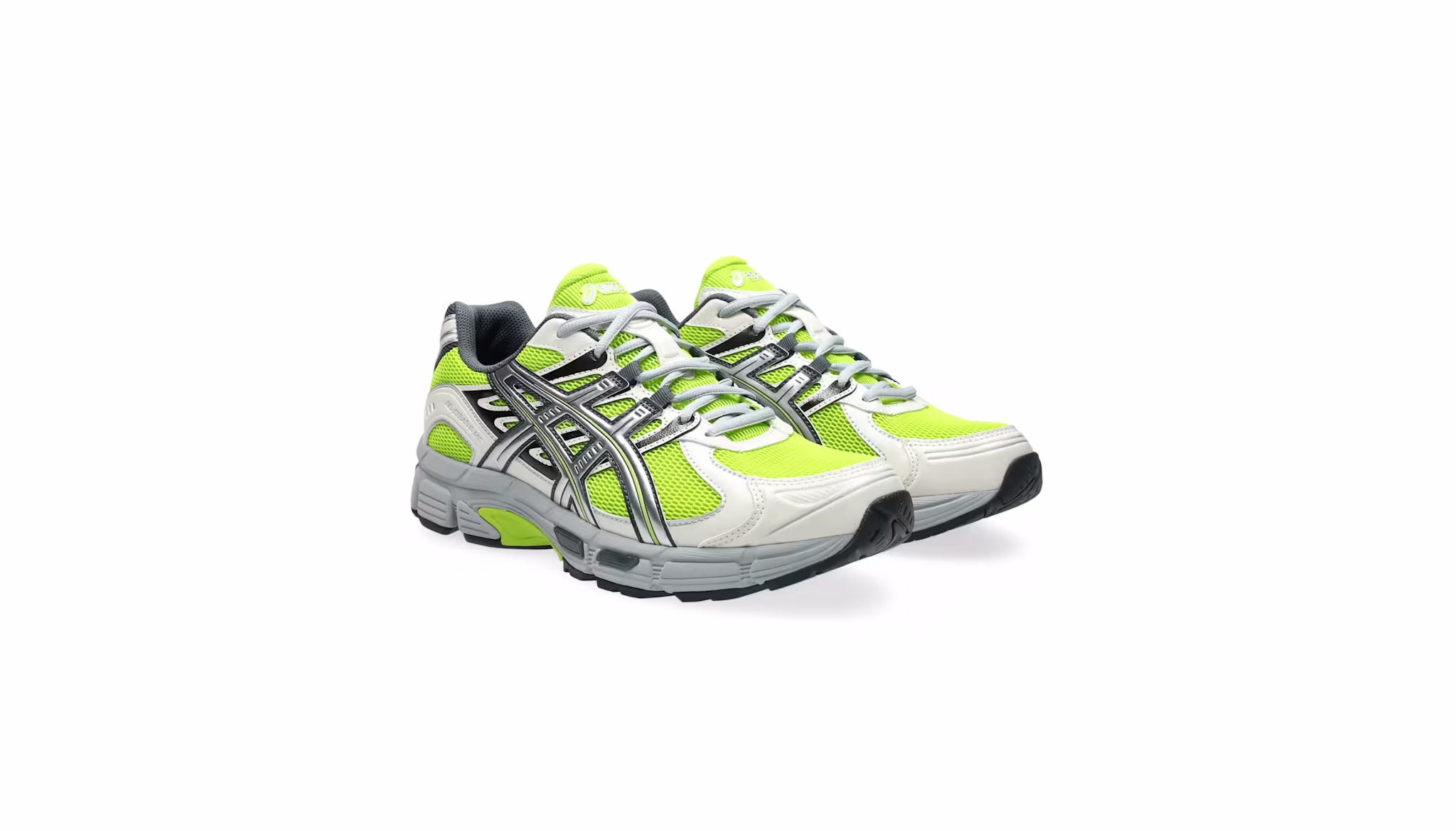 A pair of lime green and white athletic sneakers with black and silver accents, featuring a mesh design and thick soles.