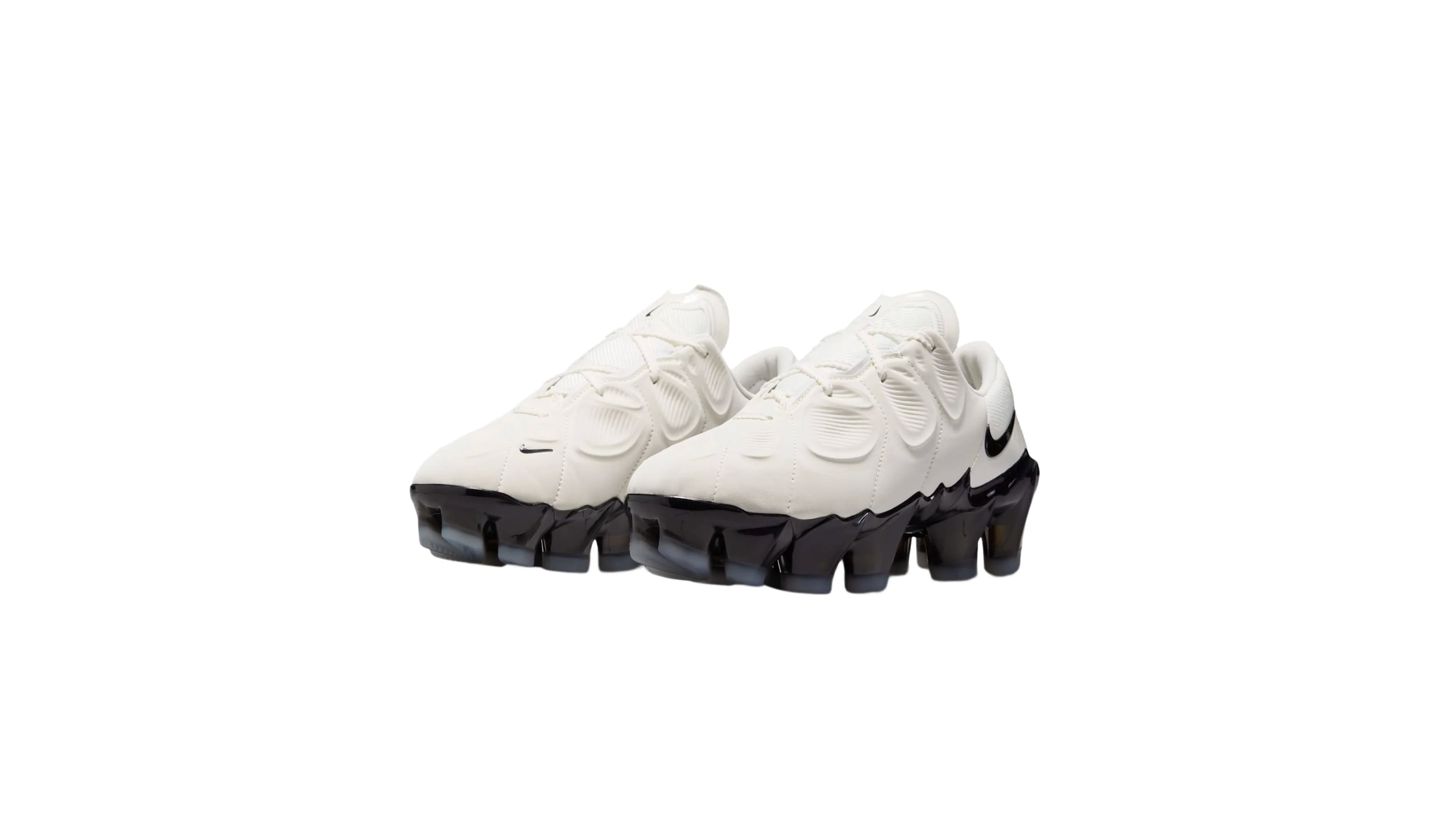 A pair of white Nike sneakers with a distinctive black sole and swoosh logo, designed with a modern, sporty aesthetic.