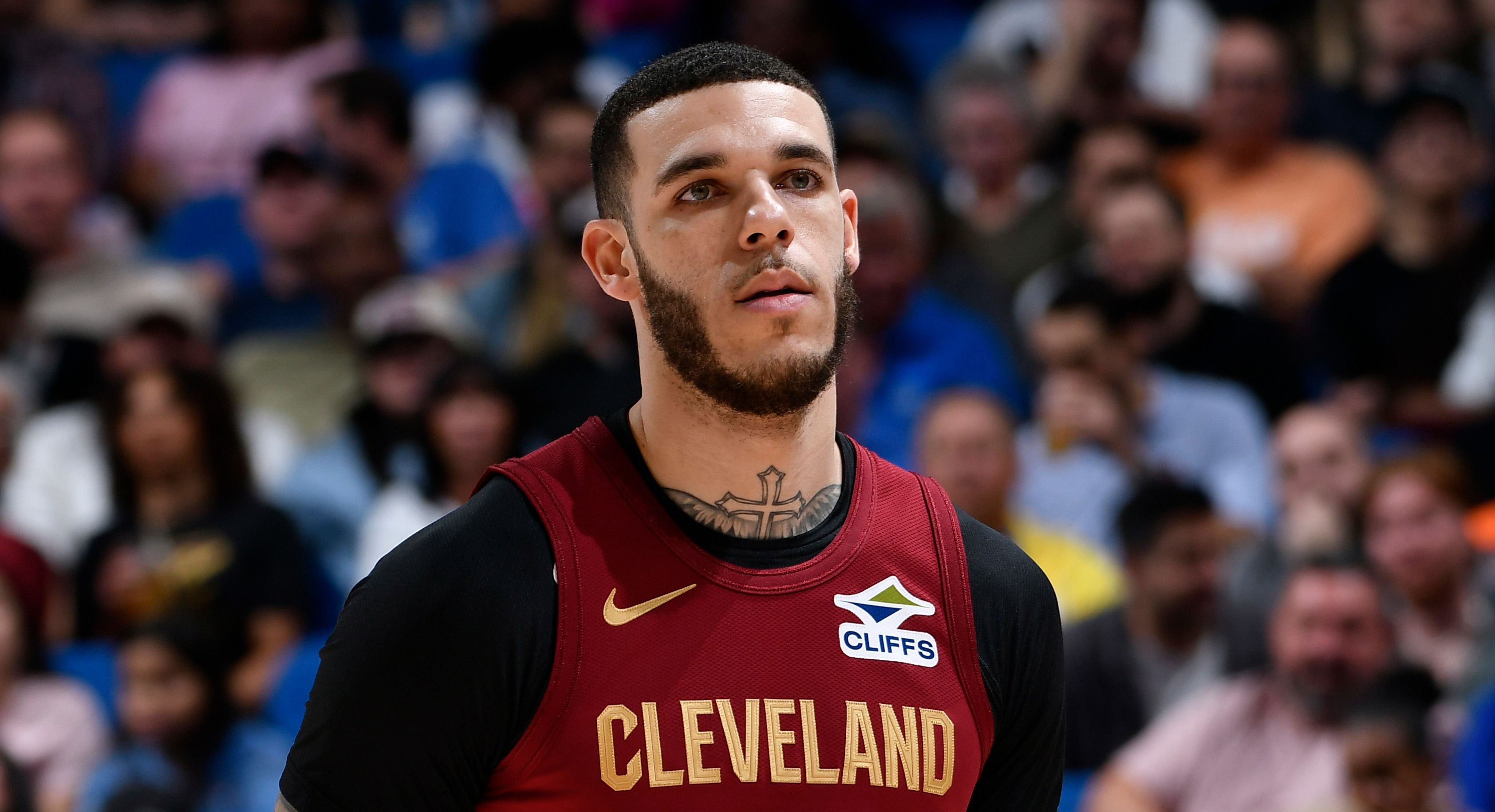 Lonzo Ball in a Cleveland jersey with number 2, standing on the court. The crowd is visible in the background.