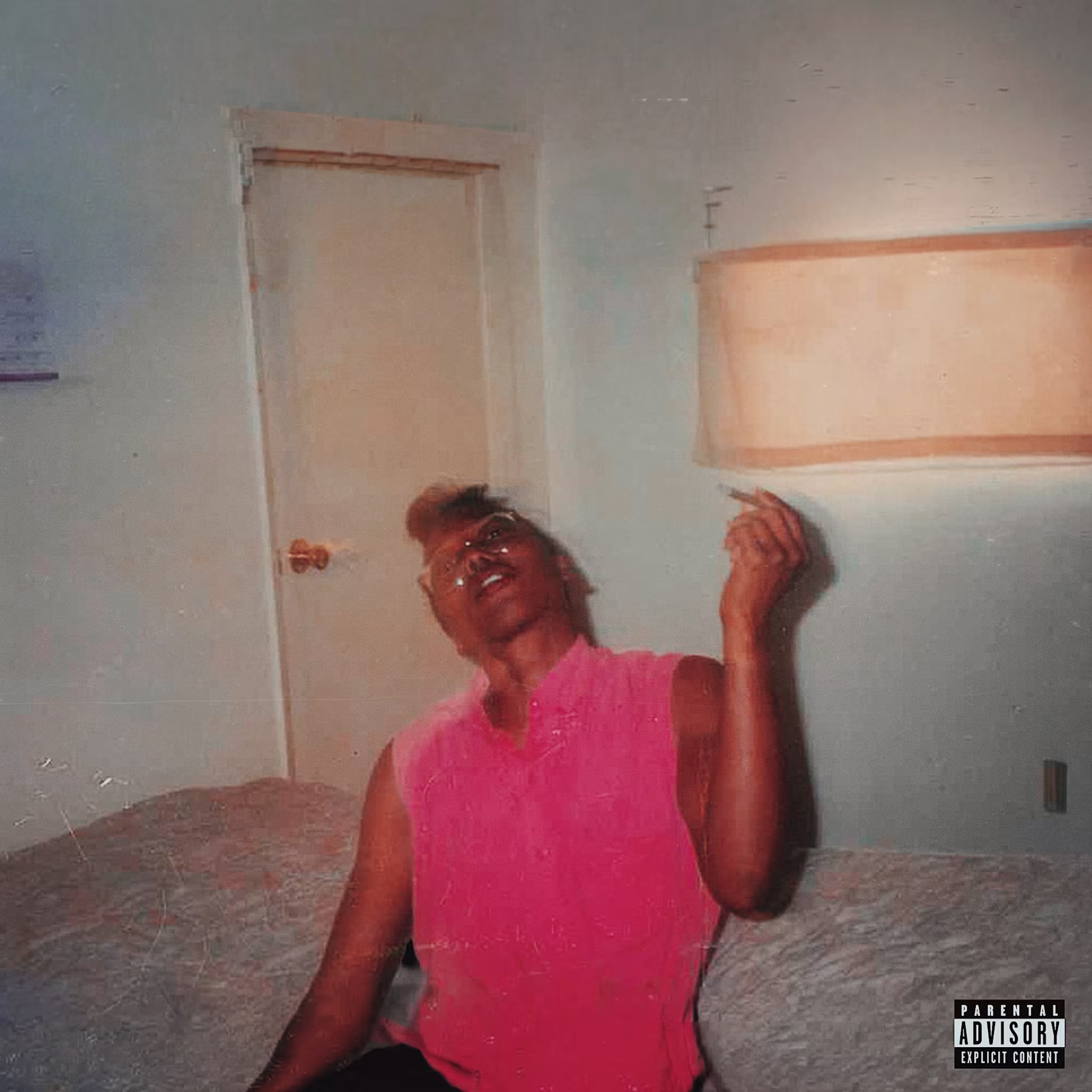 Album cover of a person in a pink shirt sits on a bed, holding a cigarette. The room has a door and a window with a shade. Explicit content label.