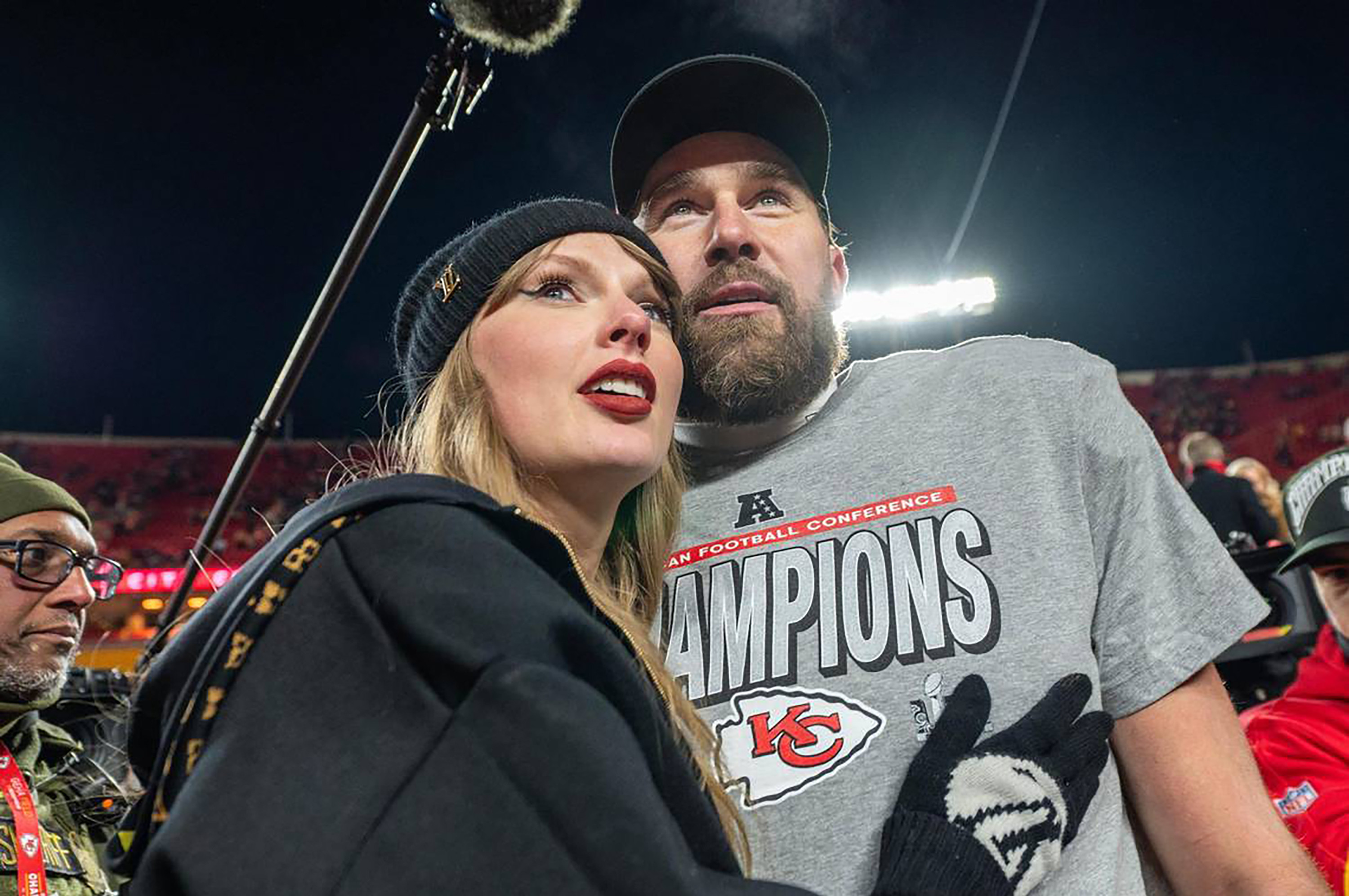 Taylor Swift and Kansas City Chiefs tight end Travis Kelce (87) walk off the field after the trophy ceremony following the Chiefs 32-29 victory over the Buffalo Bills in the AFC Championship Game on Sunday, Jan. 26, 2025, at GEHA Field at Arrowhead Stadium. 