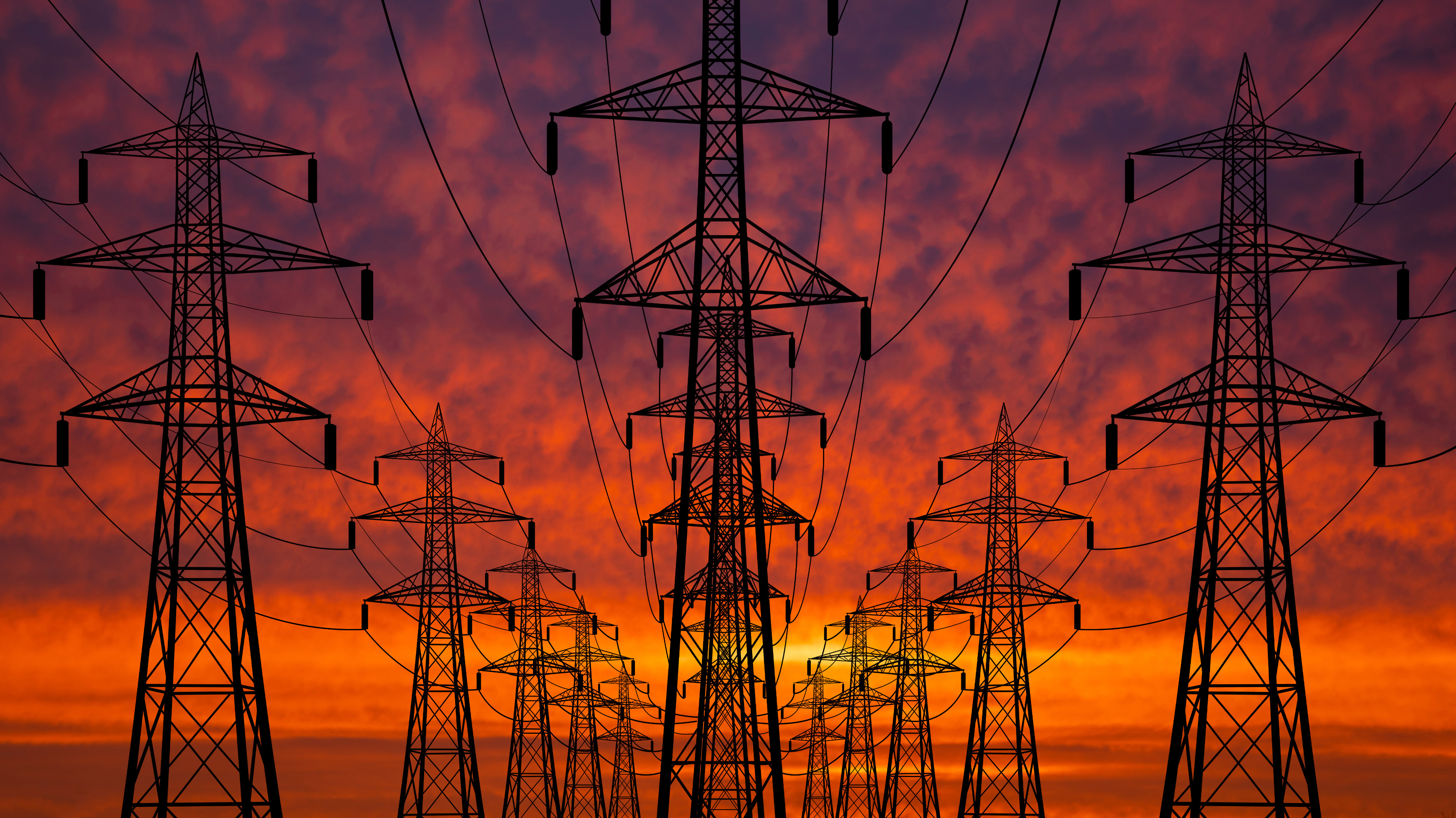 High voltage towers at sunset background. Power lines against the sky.