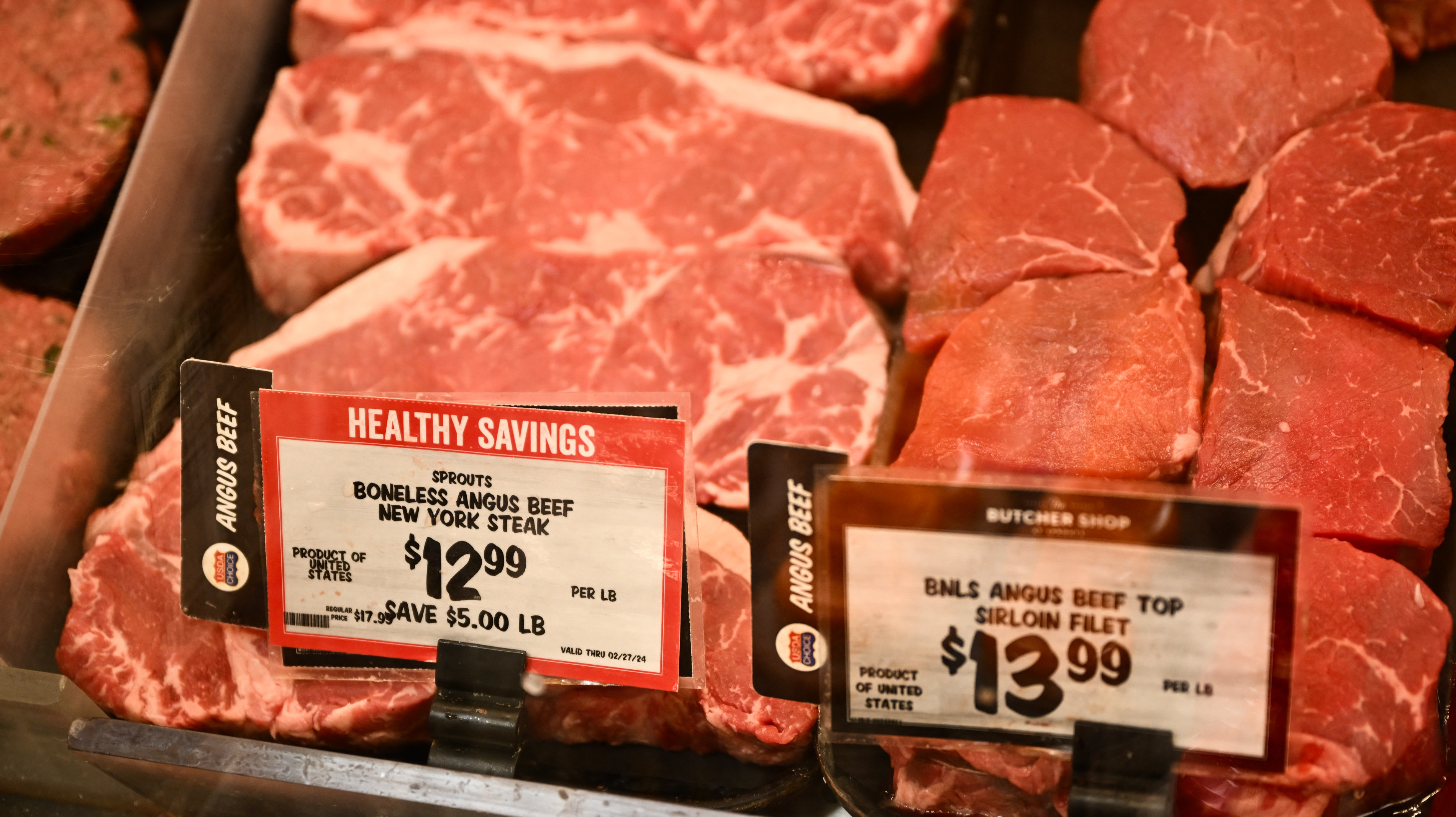 Packages of angus beef steaks and top sirloin fillets are displayed for sale in the meat area of a Sprouts Farmers Market grocery store in Redondo Beach, California on February 23, 2024. The US Federal Reserve was divided in January over the risks of cutting interest rates too soon or too late, although most members voiced concern about moving early, according to minutes of the meeting published February 21, 2024. 