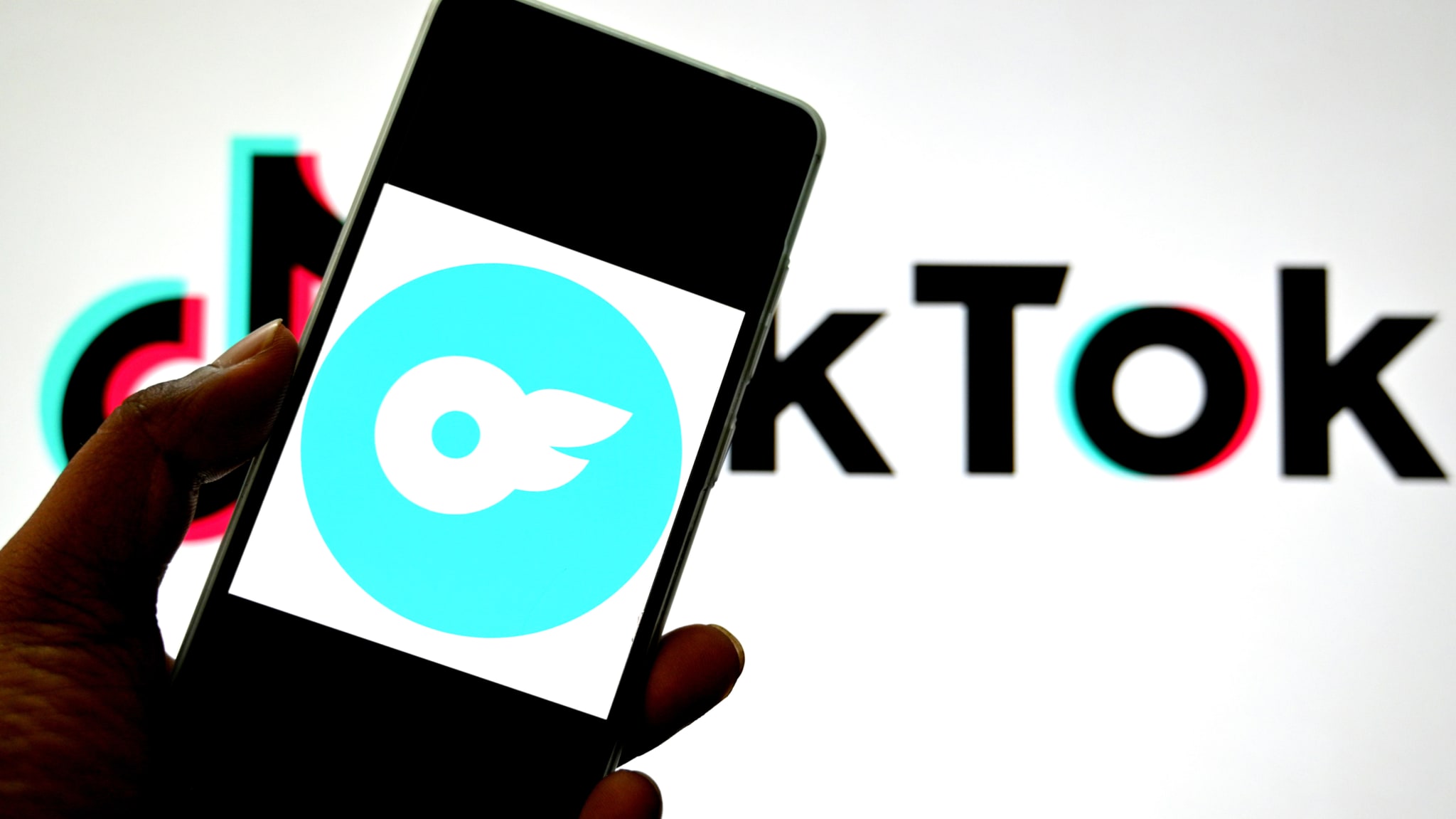  In this photo illustration, an Only fans logo is seen displayed on a smartphone with a Tiktok logo in the background. 