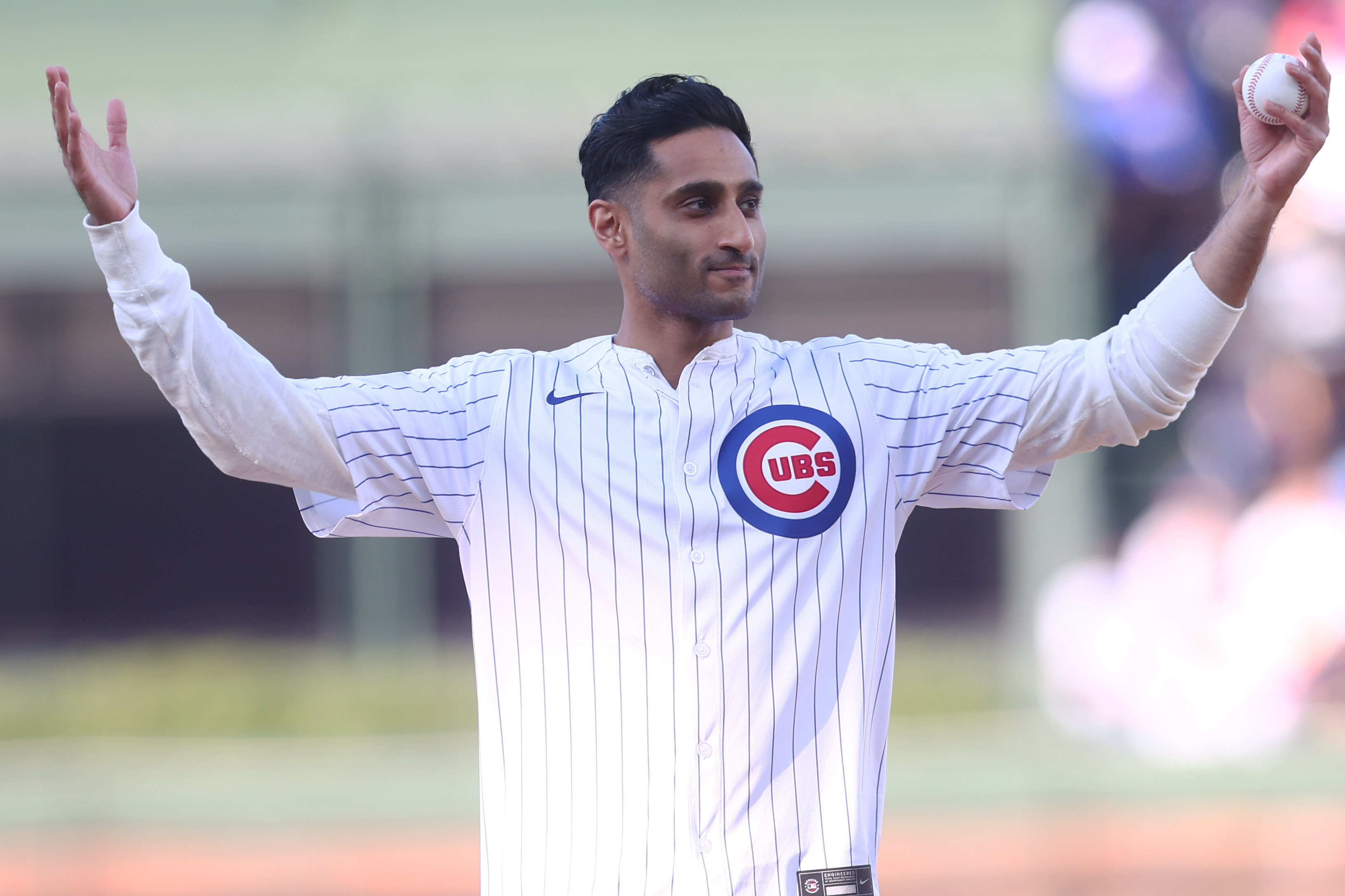 Shama Charania throws out the first pitch at Wrigley Field in April 2025. 