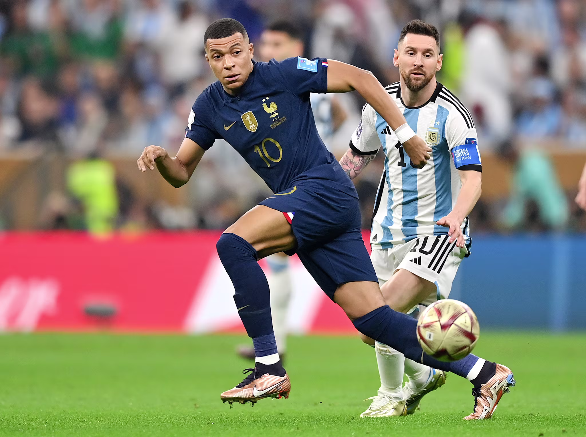 Kylian Mbappe and Lionel Messi chase after the ball during the 2022 FIFA World Cup finals. 