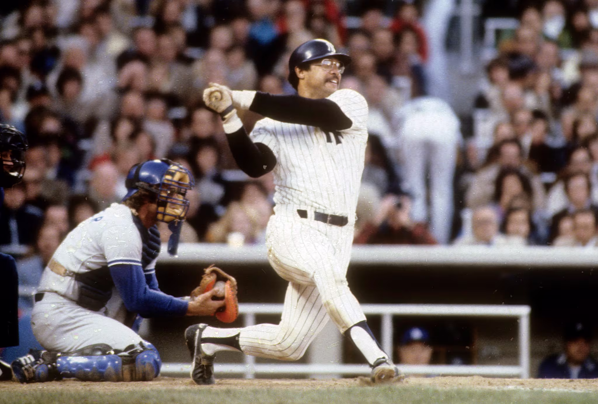 Reggie Jackson hits the third of three consecutive home runs in Game 6 of the 1977 World Series. 