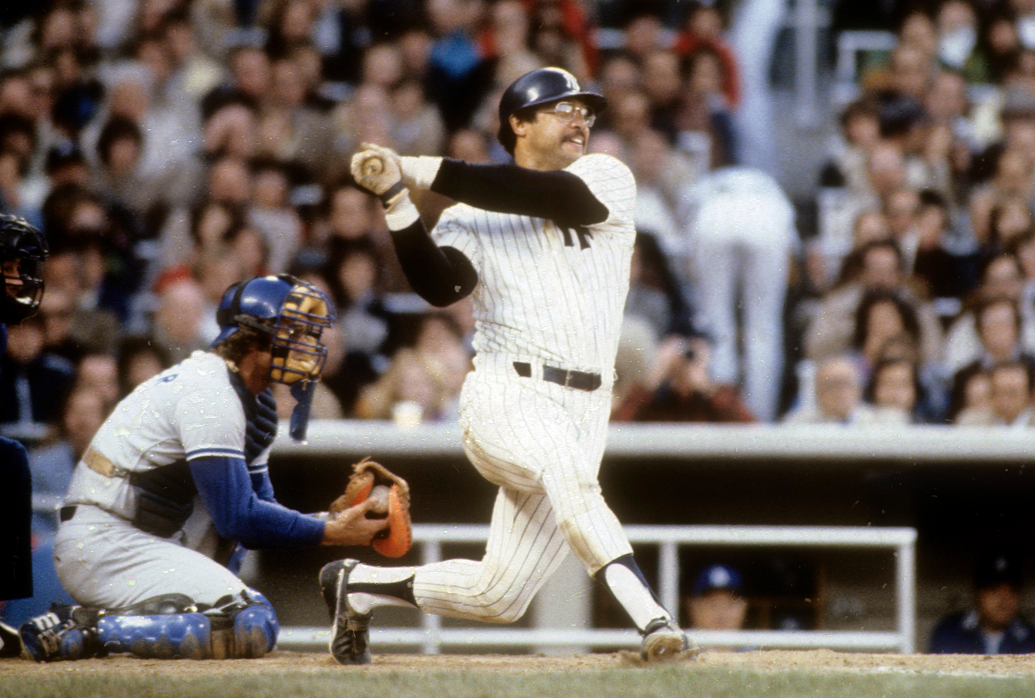 Reggie Jackson hits the third of three consecutive home runs in Game 6 of the 1977 World Series. 