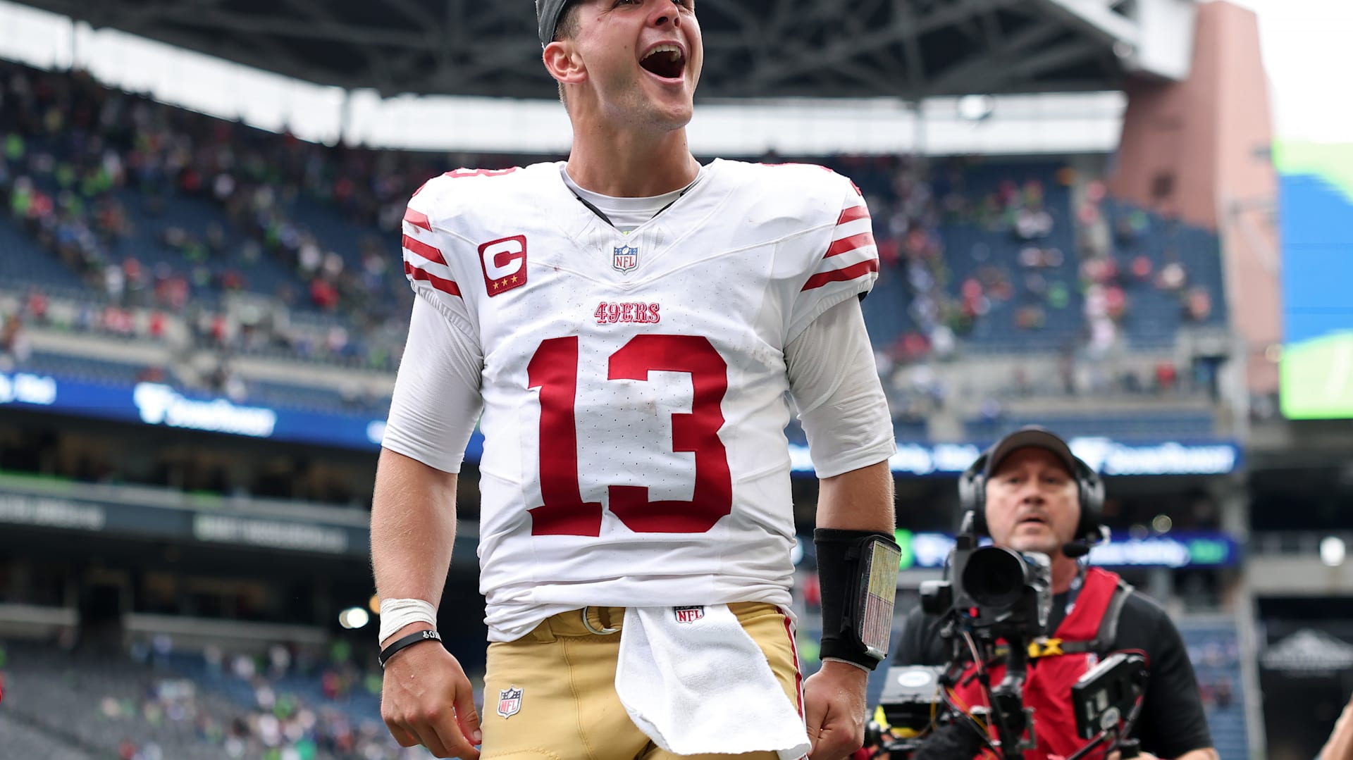 Brock Purdy drops back to pass during a San Francisco 49ers game. 