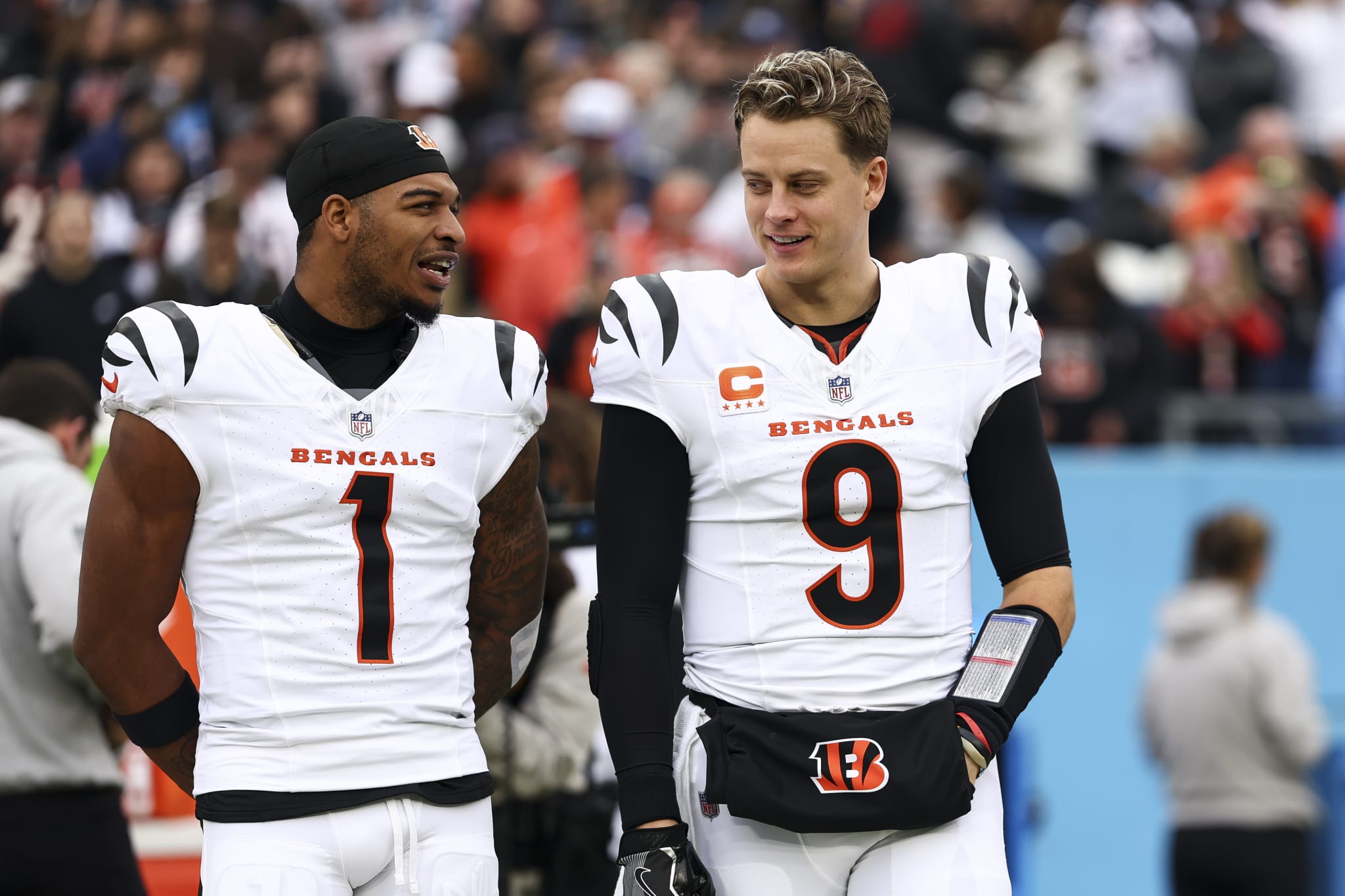 Joe Burrow and Ja'Marr Chase talk strategy before a December 2024 game against the Titans. 