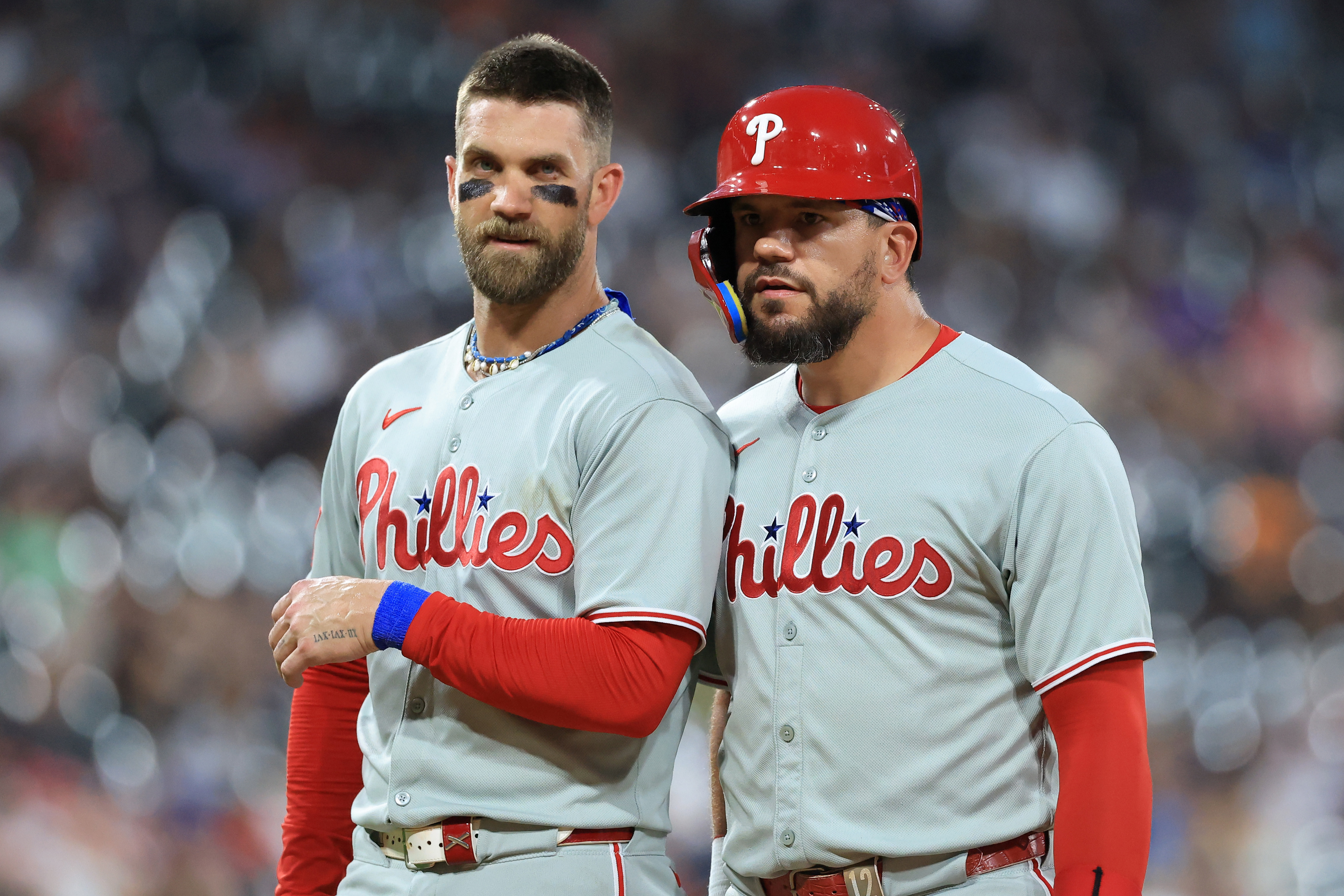 Bryce Harper and Kyle Schwarber look on during a Philadelphia Phillies game in 2025. 
