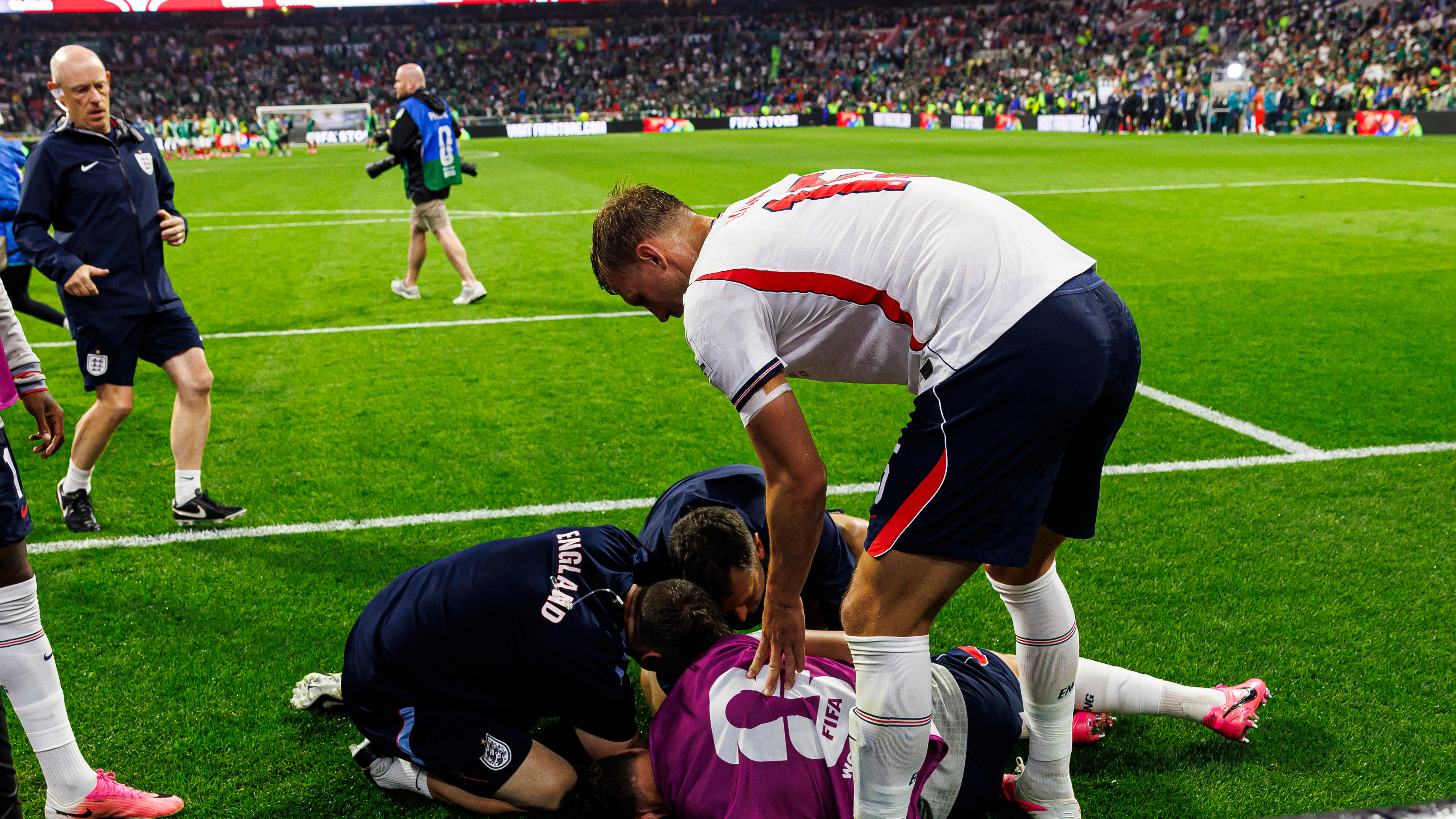 Dan Burn of England (R) tries to help his teammate Jordan Henderson who was injured amid the celebrations after winning the FIFA World Cup 2026 Round Of 16 match between Mexico and England at Mexico City Stadium on July 5, 2026 in Mexico City, Mexico.