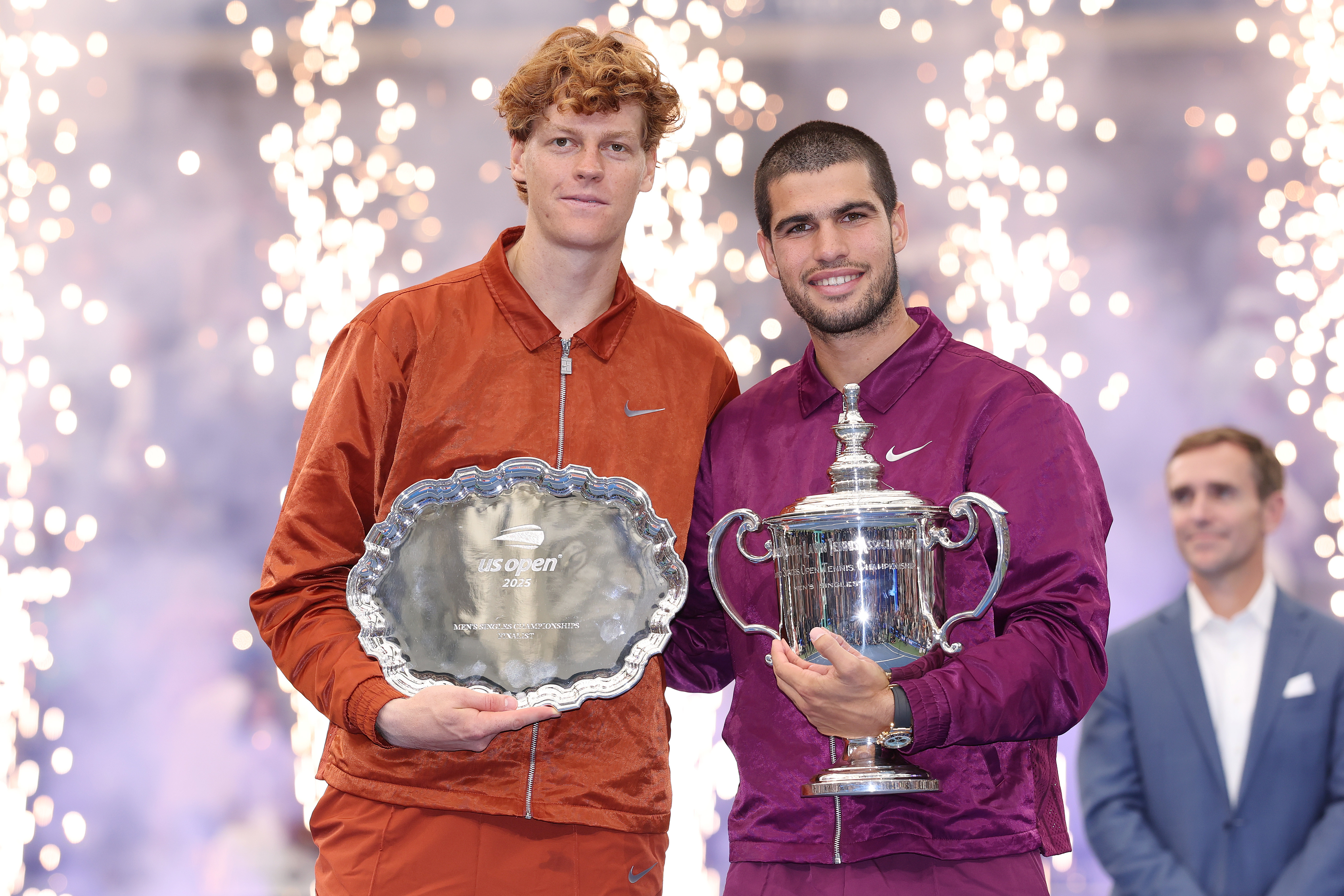 Jannik Sinner and Carlos Alcaraz pose with their trophies after the 2025 US Open Men's Final. 