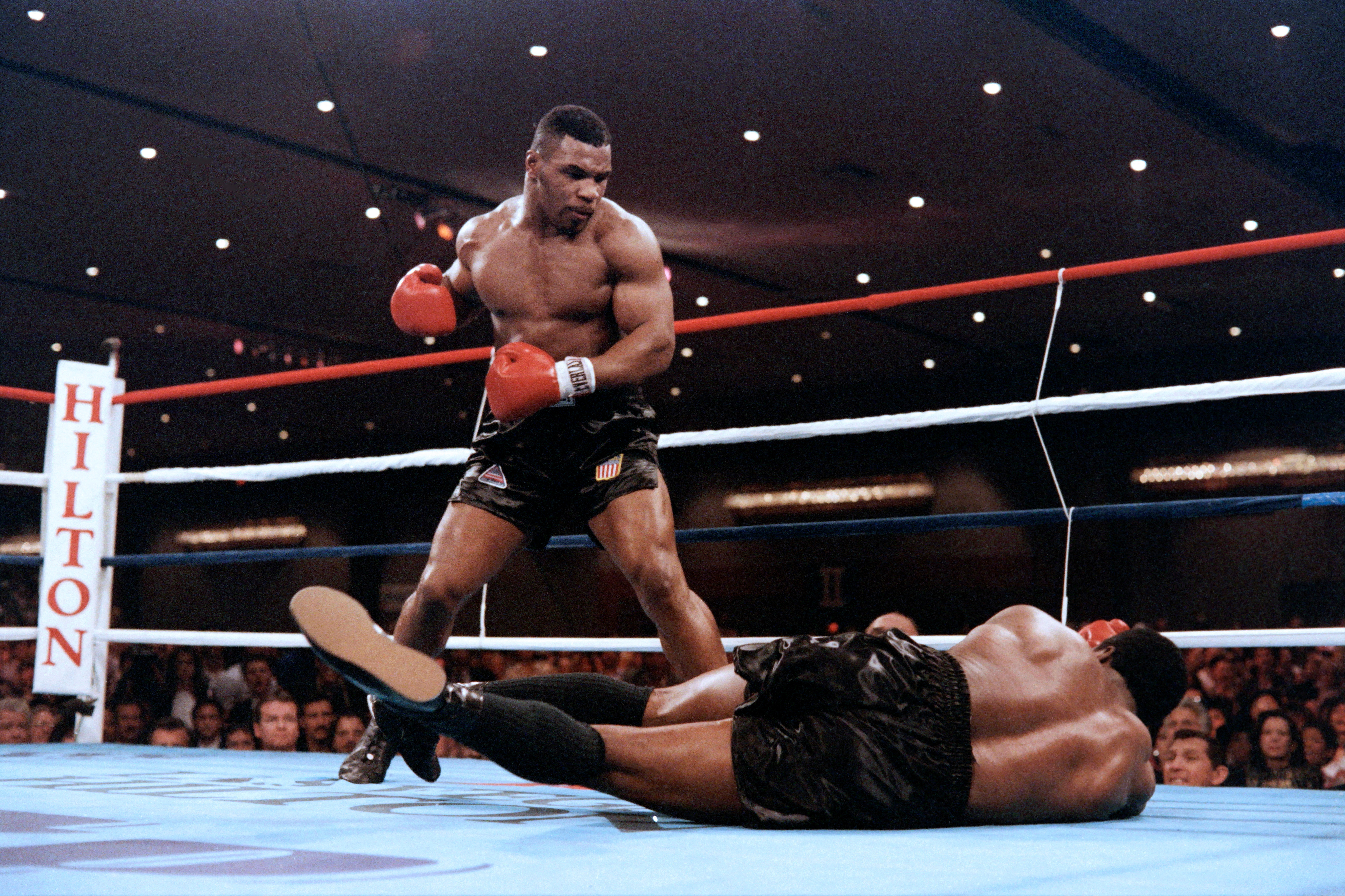 Mike Tyson stands above Trevor Berbick after knocking him out. 