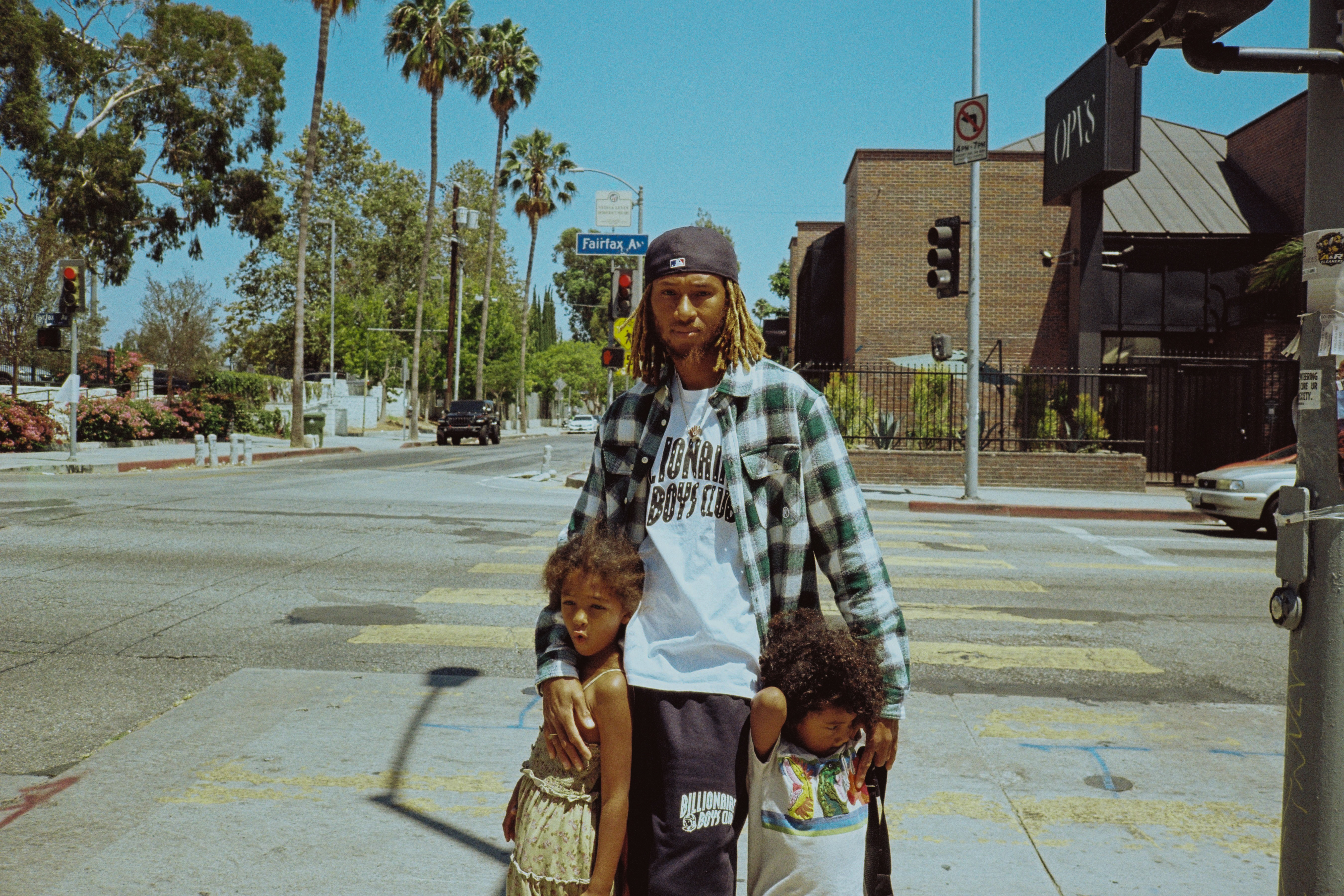 Anwar Carrots poses on a corner of Fairfax Avenue in Los Angeles wearing Billionaire Boys Club to tease his upcoming collab with the brand at ComplexCon 2026.