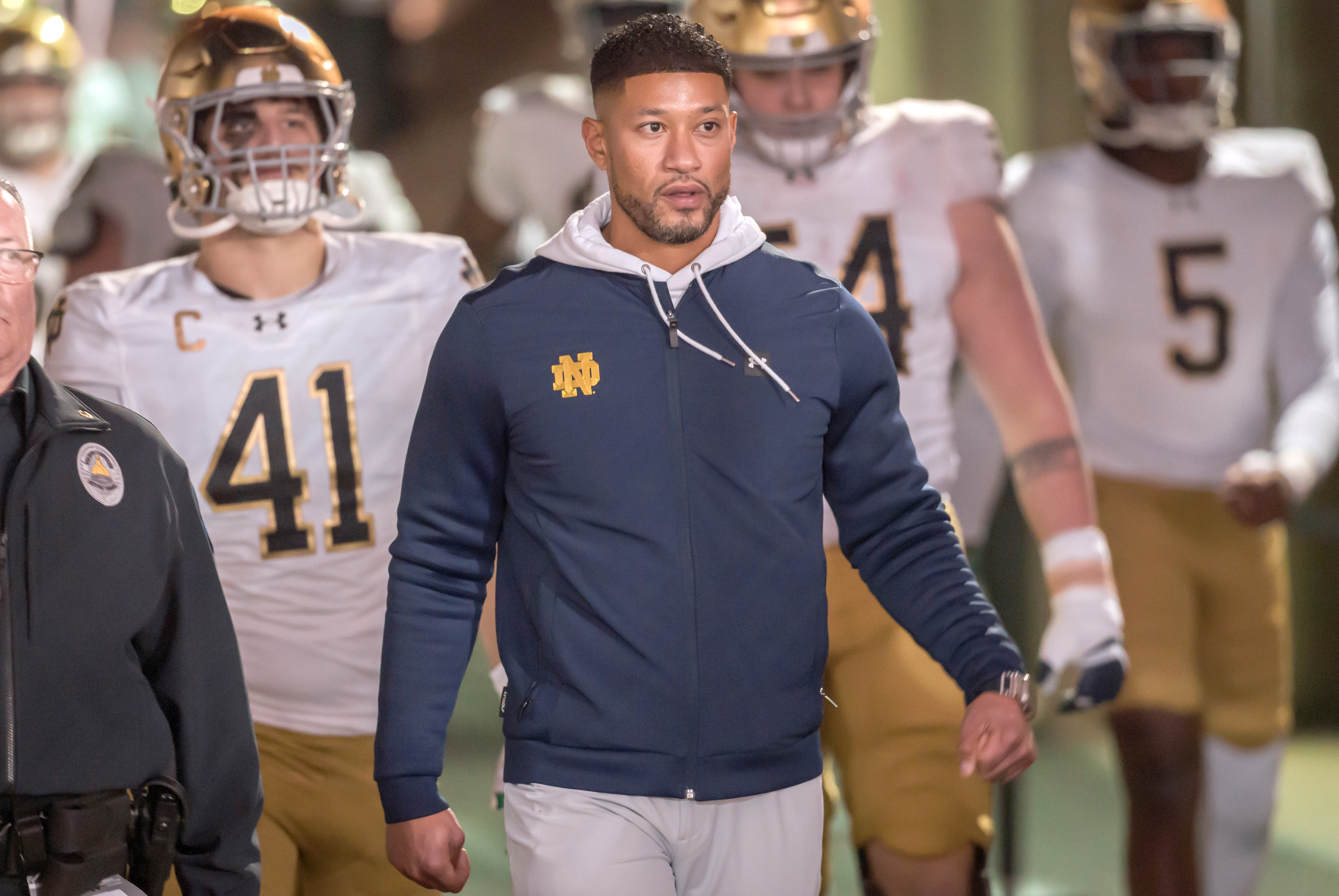 Notre Dame head coach Marcus Freeman leads the Fighting Irish onto the field before a game in November 2025. 