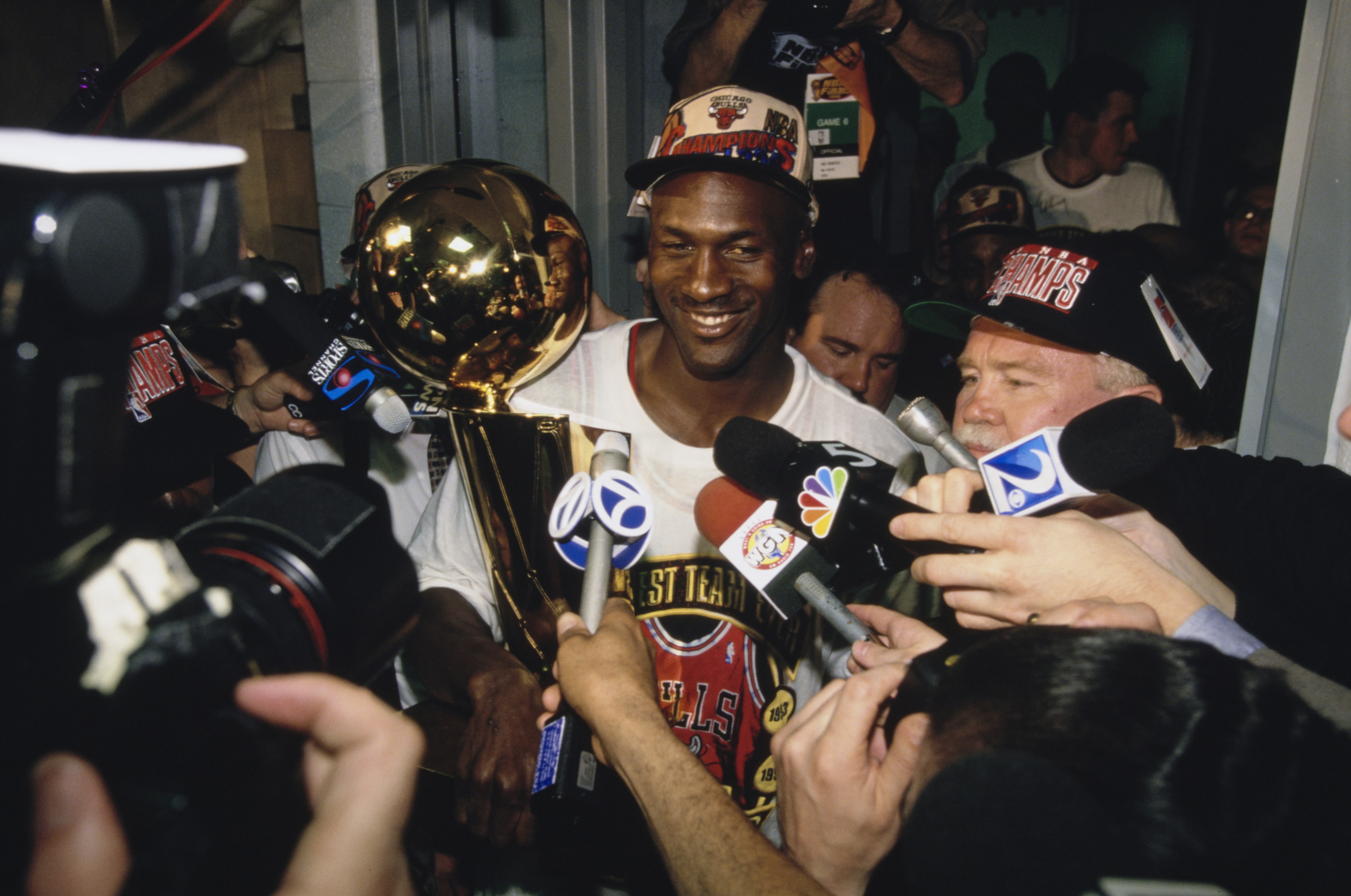 Michael Jordan surrounded by reporters after winning the 1996 NBA Championship. 