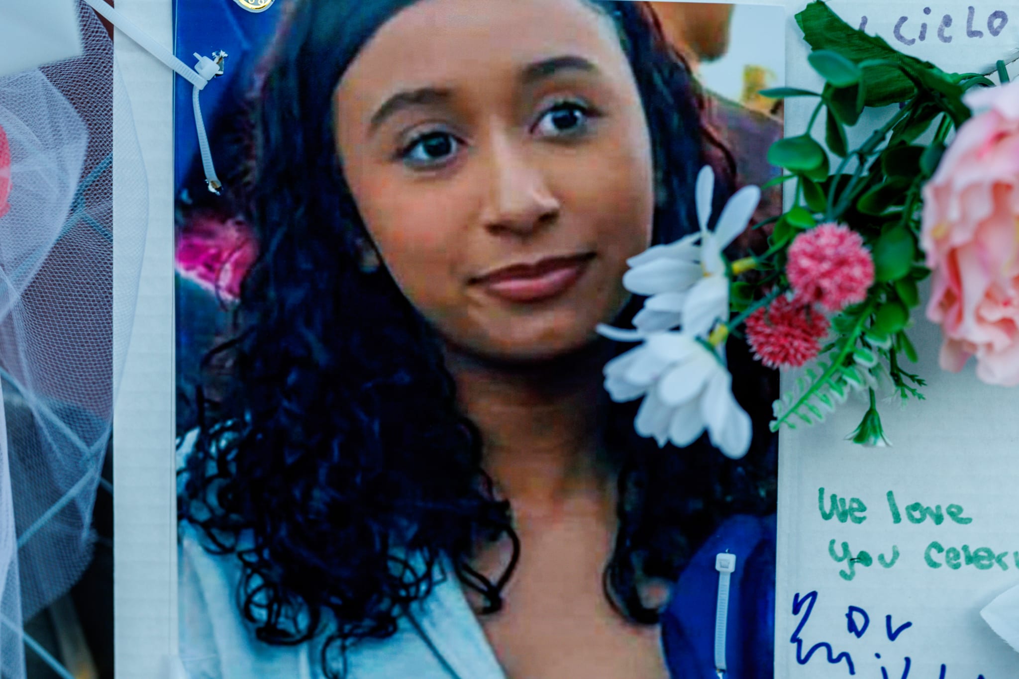 Celeste Rivas with curly hair is pictured, surrounded by flowers and a note saying "We love you."