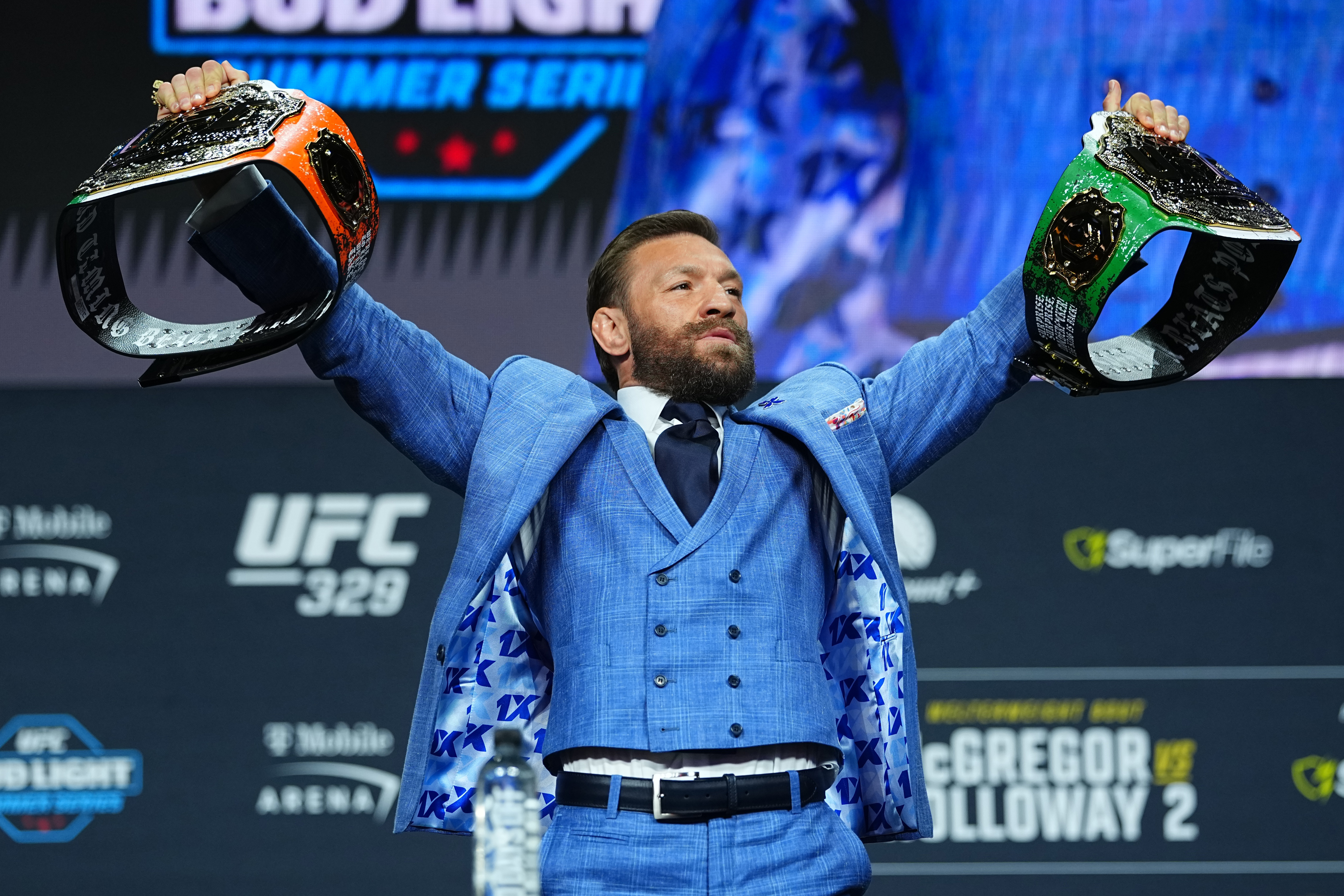 Conor McGregor taunts the crowd at the press conference for his fight against Max Holloway on July 11. 