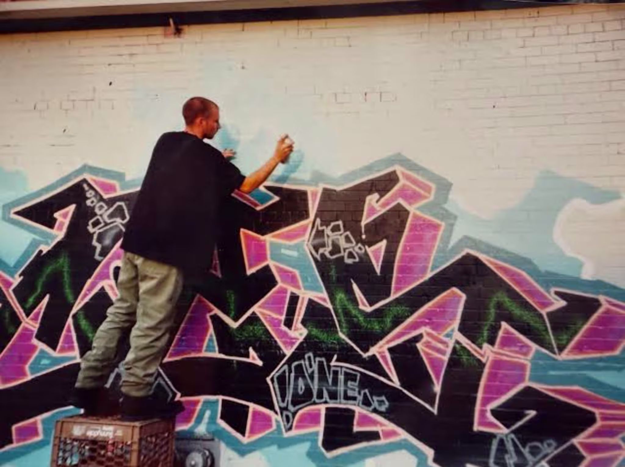 Graffiti legend CES tags a wall.