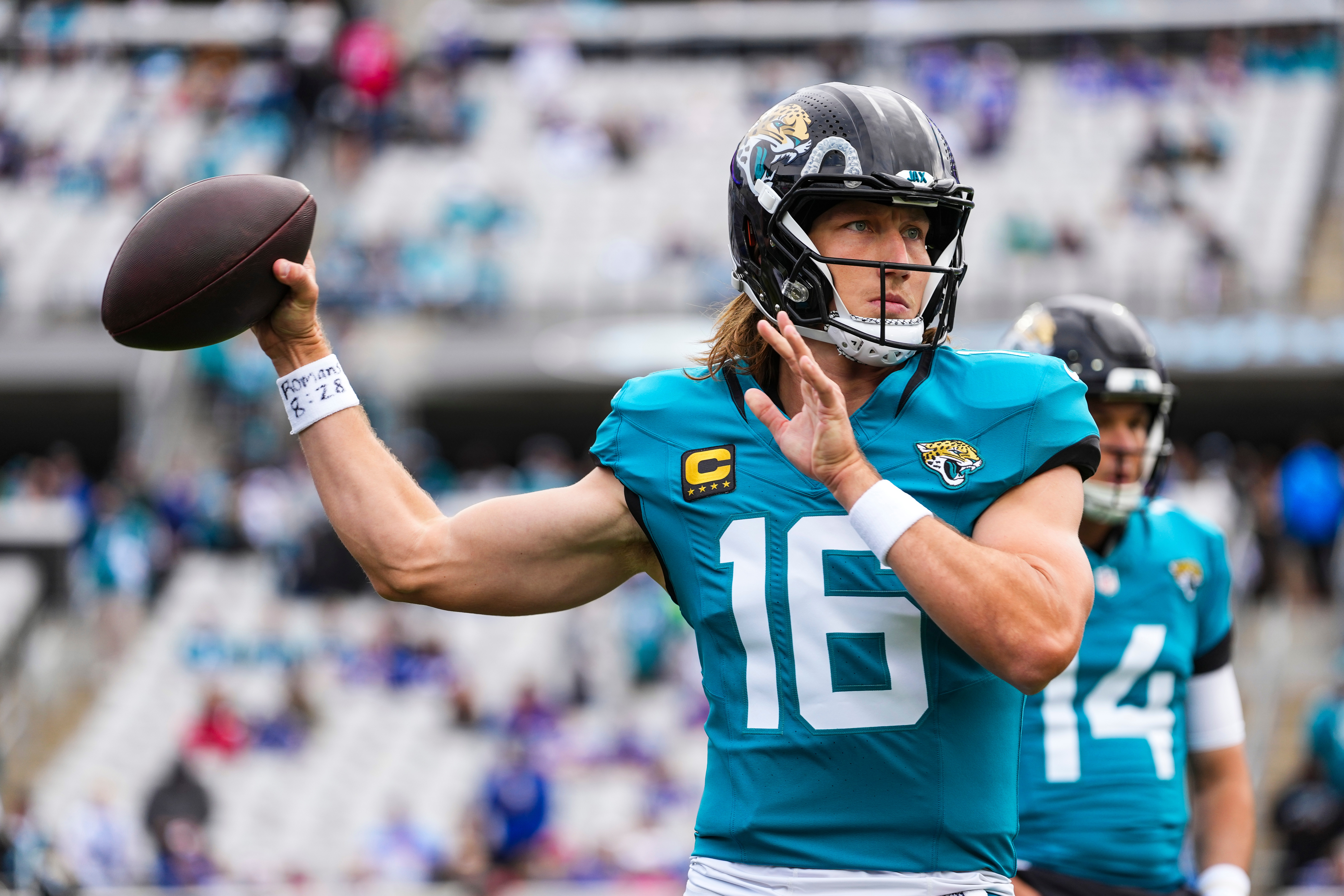 Trevor Lawrence throws a pass while warming up before the Jacksonville Jaguars-Buffalo Bills playoff game. 