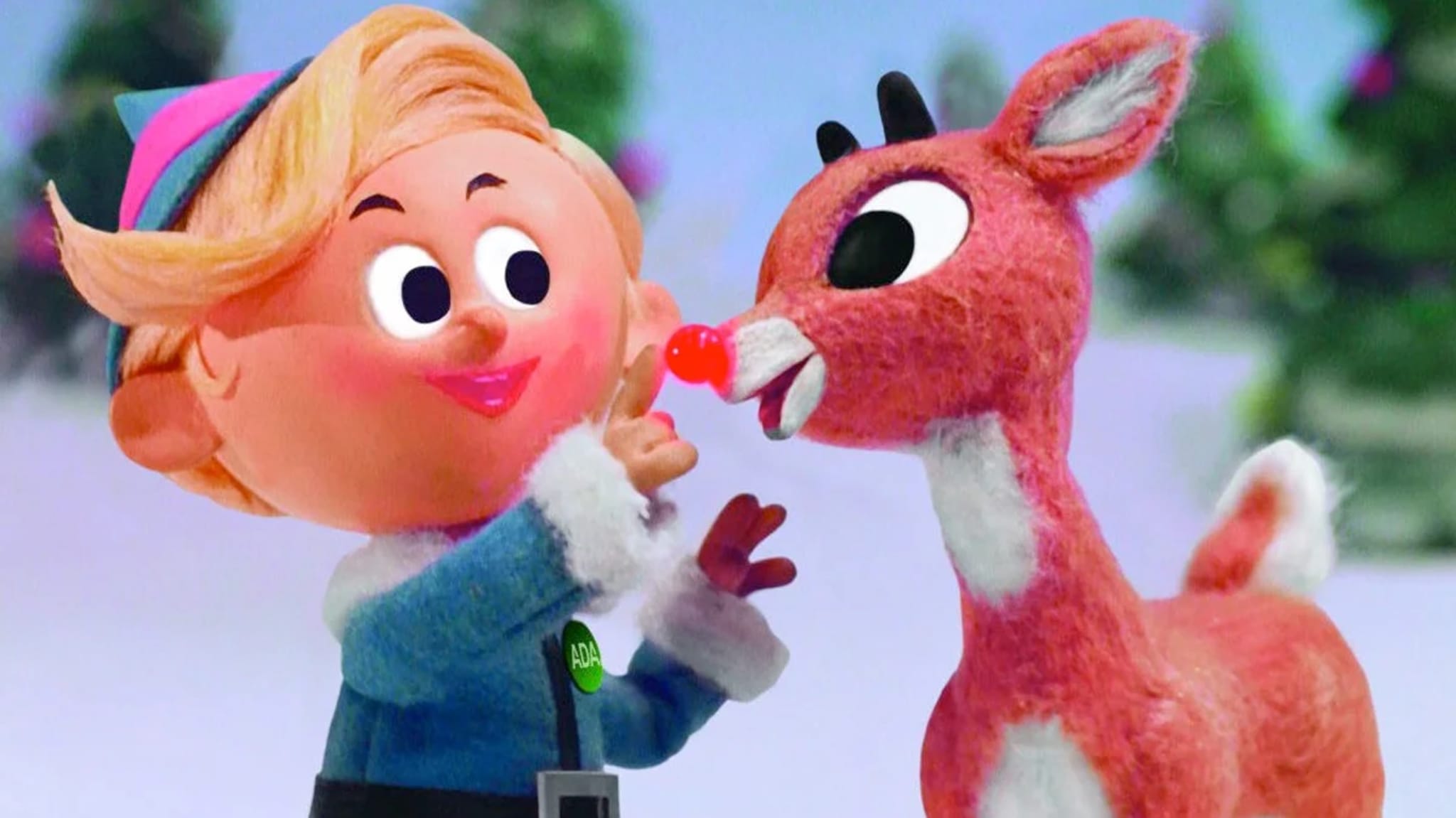 An animated scene featuring Hermey the elf and Rudolph the Red-Nosed Reindeer in a snowy setting.