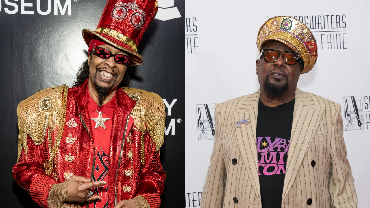 Two men in colorful, flamboyant outfits. The left wears a red hat and jacket with gold accents. The right wears a striped jacket and hat.