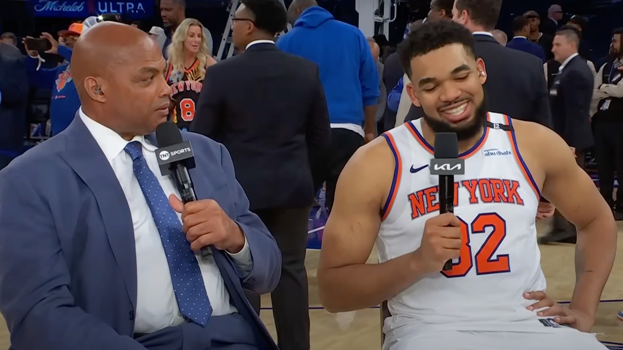Charles Barkley is interviewing Karl-Anthony Towns in a New York Knicks jersey on a basketball court.