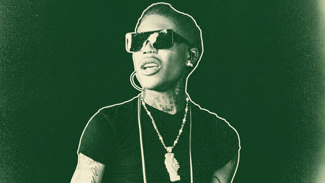A person wearing sunglasses, a black shirt, and a necklace, with a green tint effect on the image.