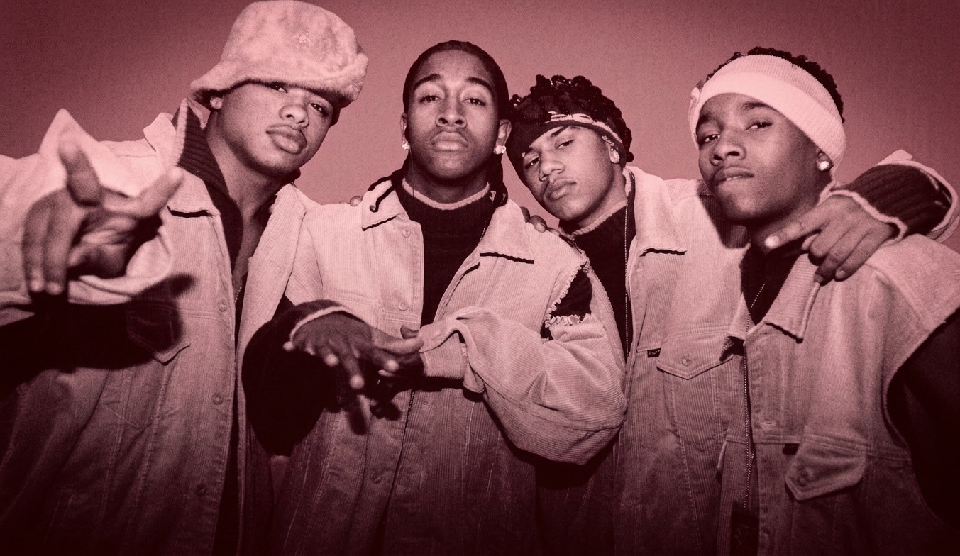 Four young men in coordinated outfits, wearing beige vests and red tops, pose together. They have various headwear and accessories.