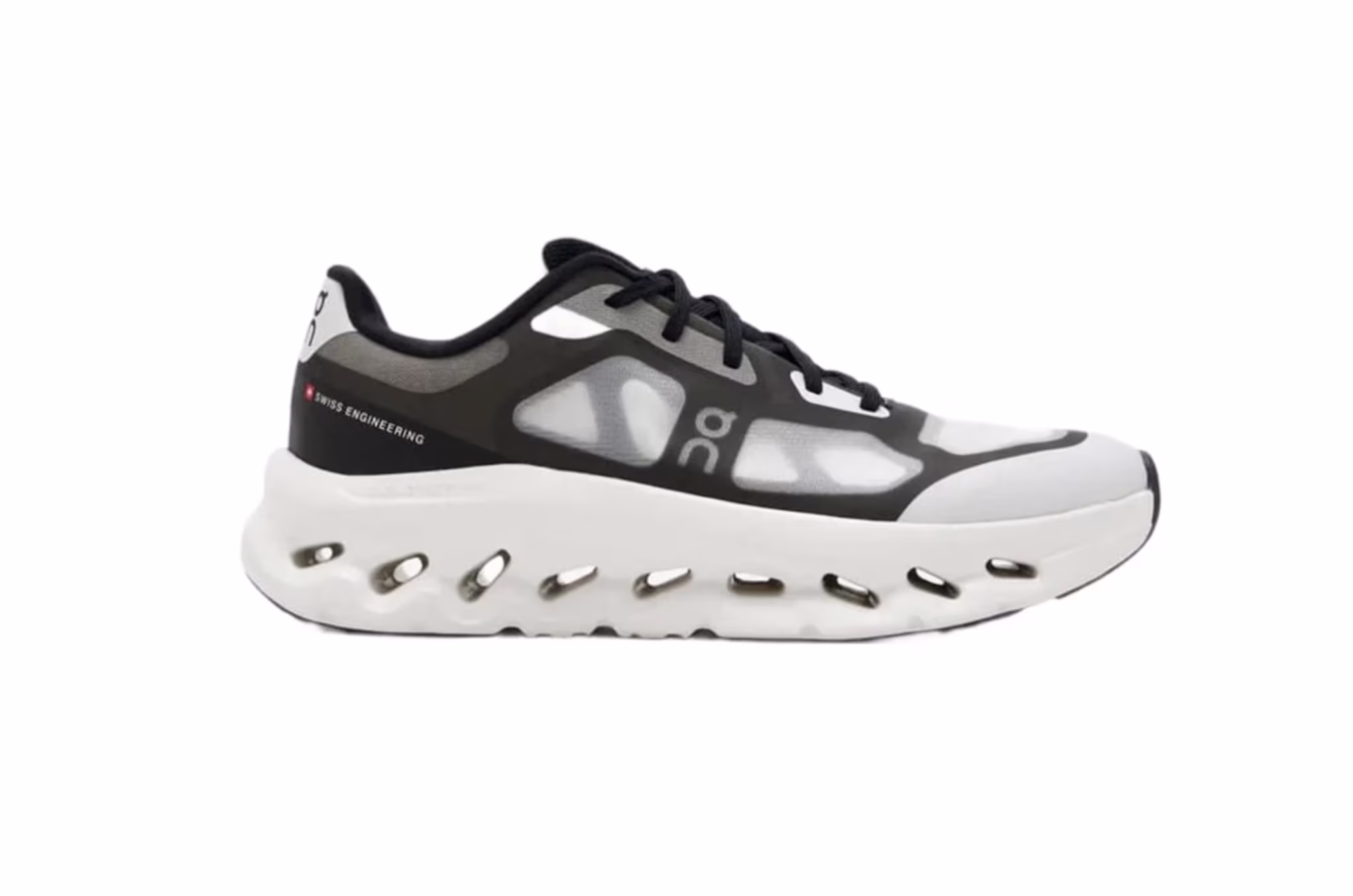 A black and white athletic shoe with a distinctive sole design, featuring mesh panels and branding on the side.