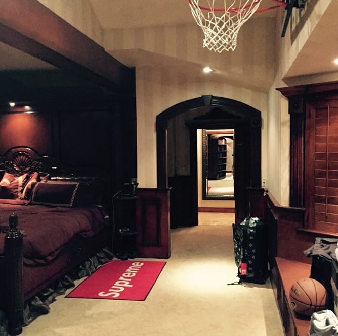 drake's bedroom is decorated with a supreme rug and a basketball