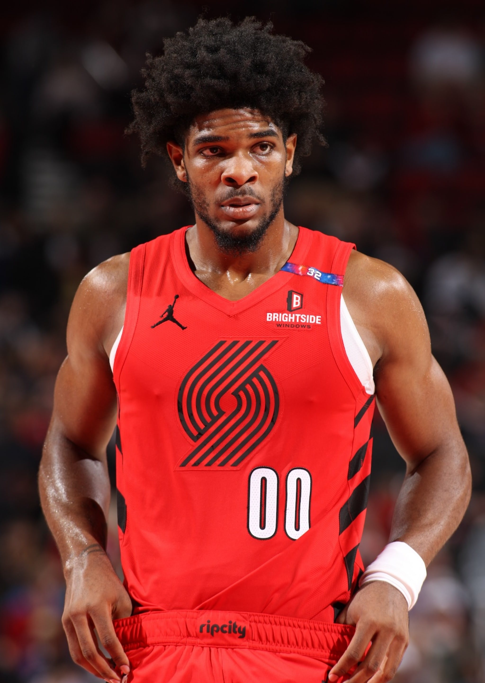Scoot Henderson wearing a red Portland Trail Blazers jersey with number 00, standing on the court.