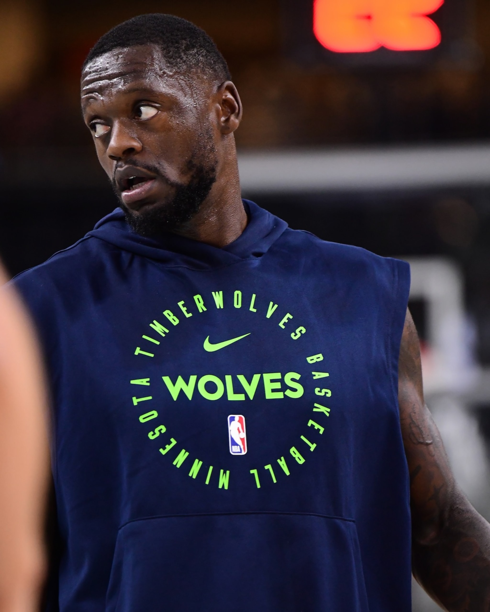 Julius Randle wearing a Minnesota Timberwolves hoodie, looking to the side.