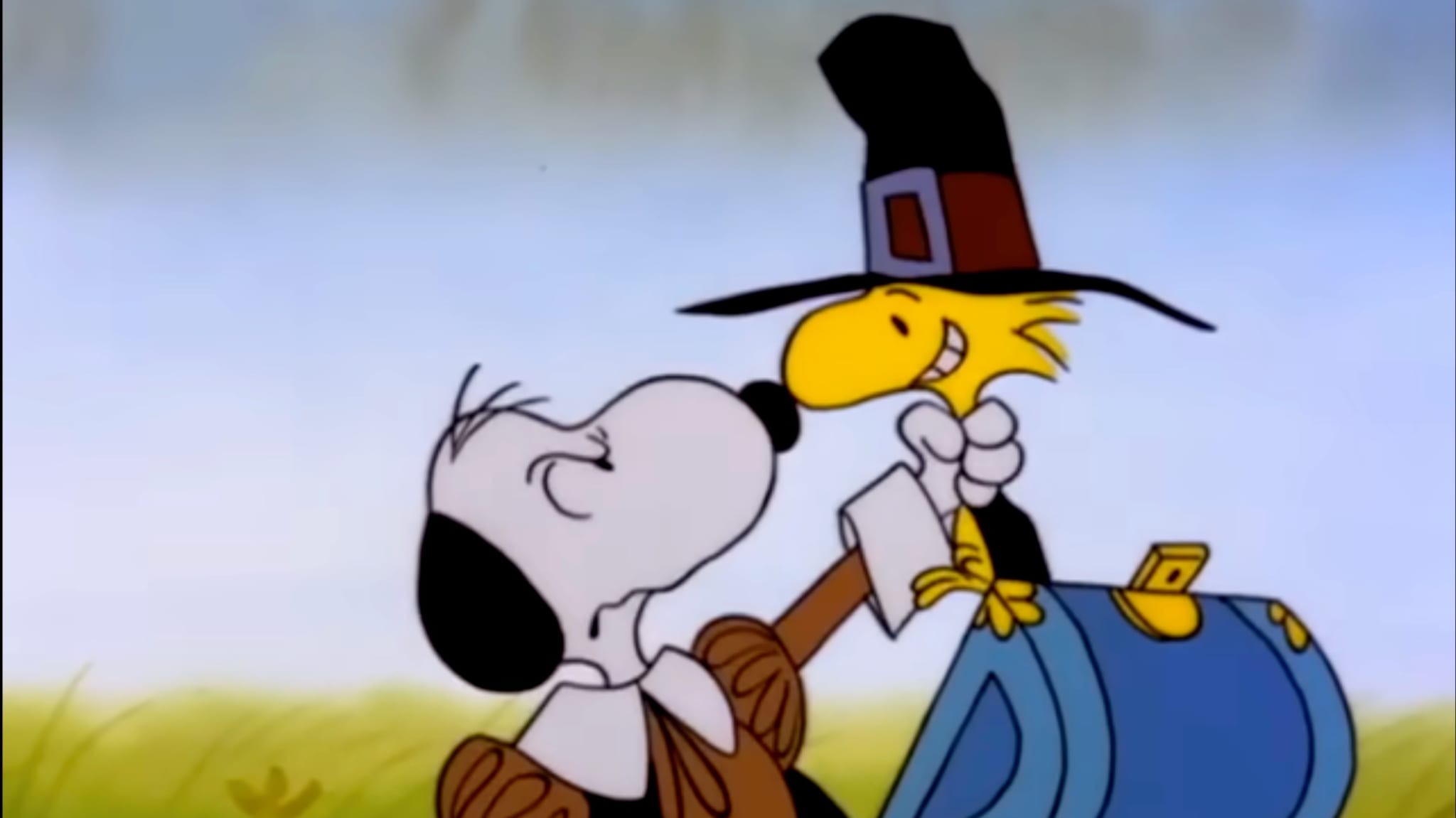 Snoopy (left) gripes Woodstock's (right) neck while inside a blue chest.
