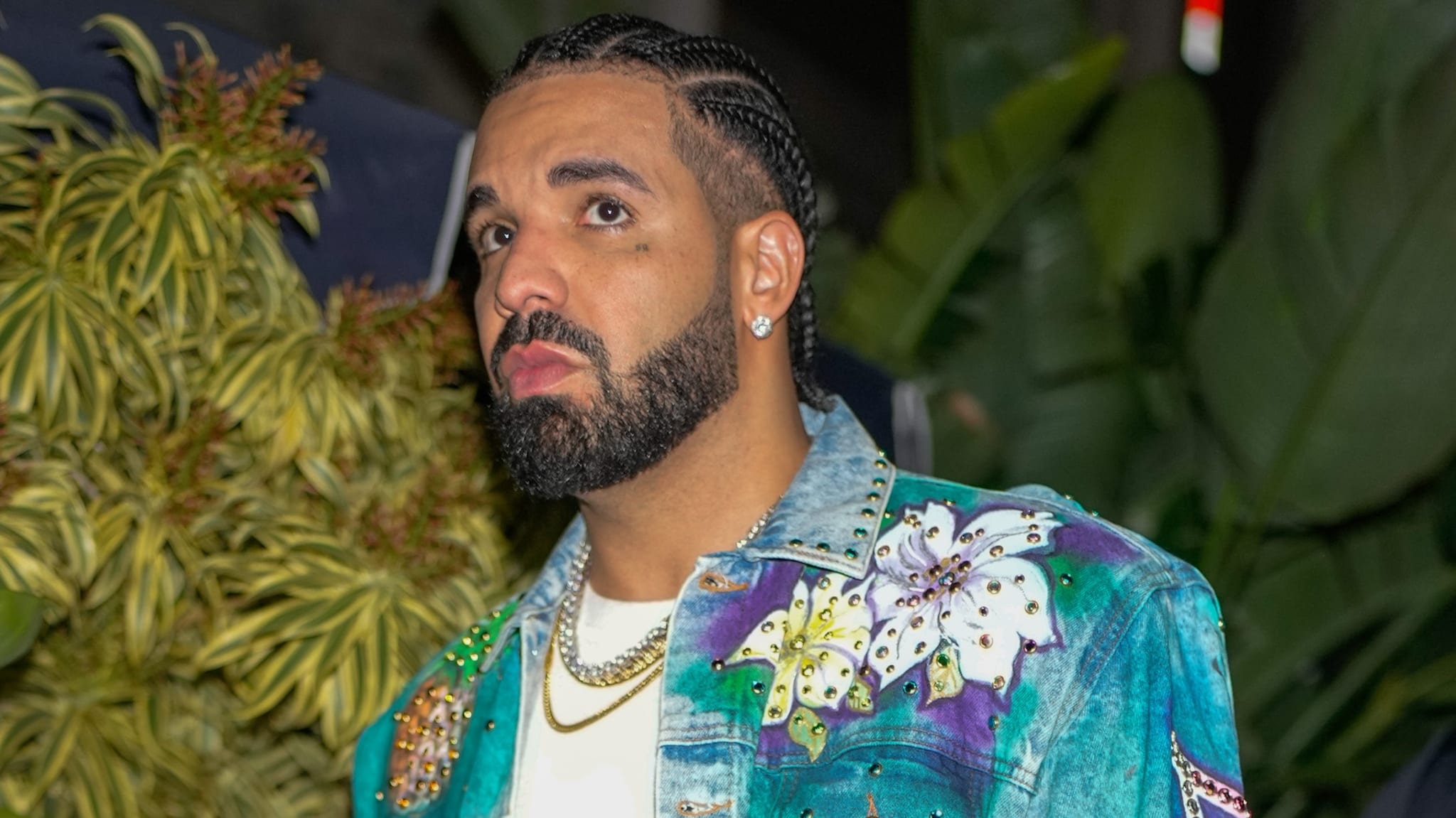 Drake walking with a frown on his face