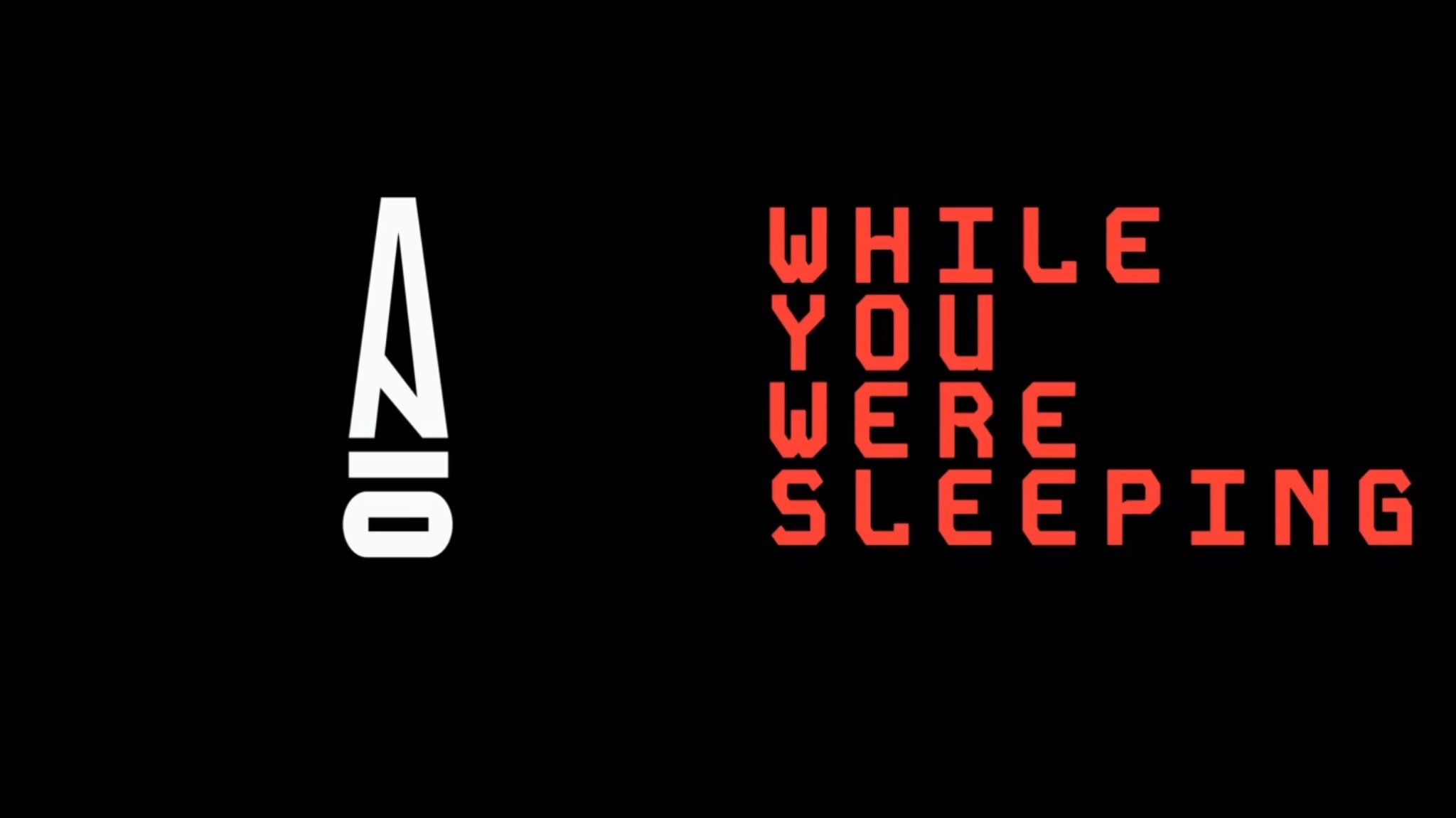 Black background with stylized white text "ANO" on the left and red text "WHILE YOU WERE SLEEPING" on the right.
