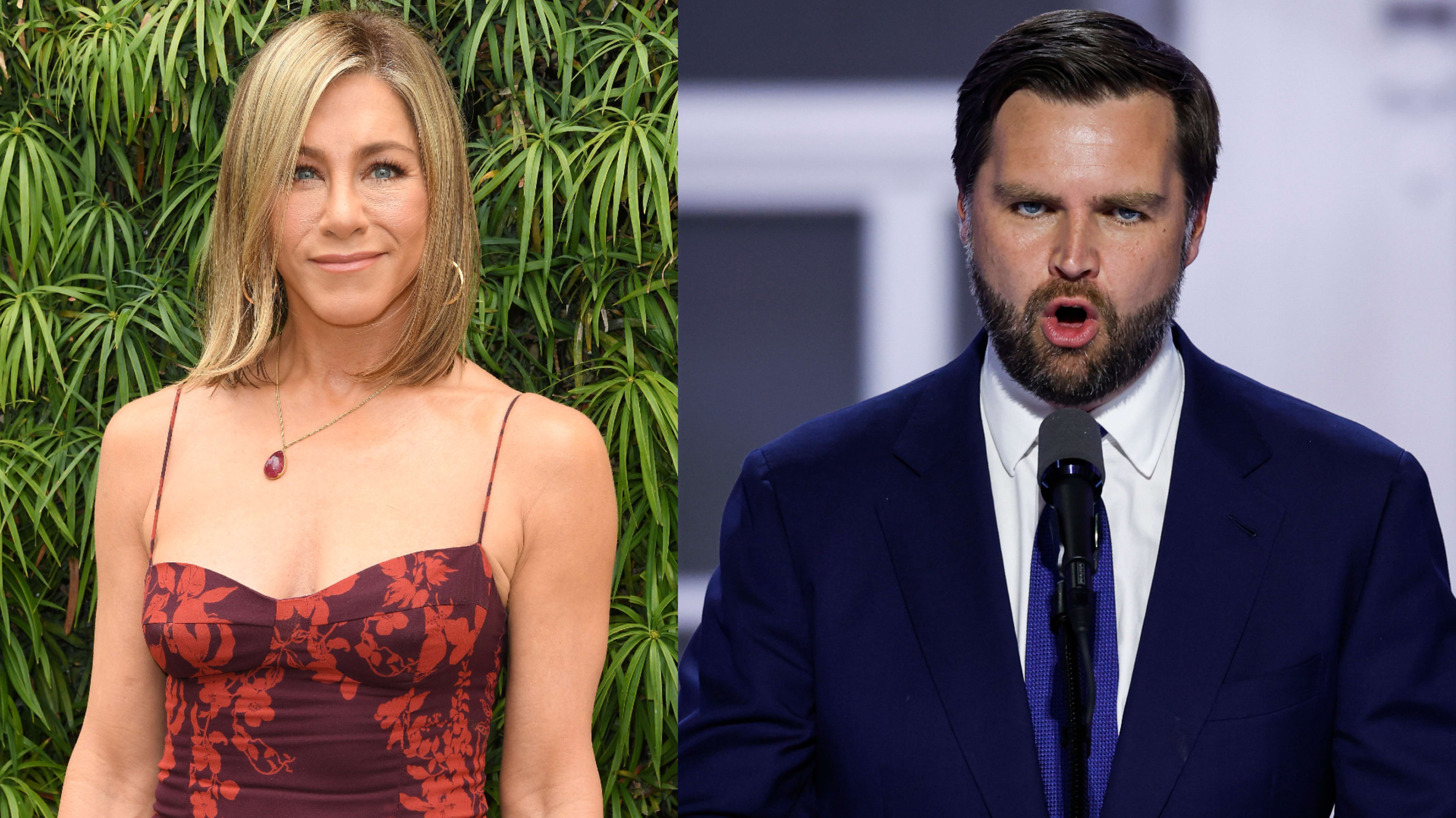 Jennifer Aniston in a sleeveless floral dress stands beside a man in a blue suit and tie speaking at a podium