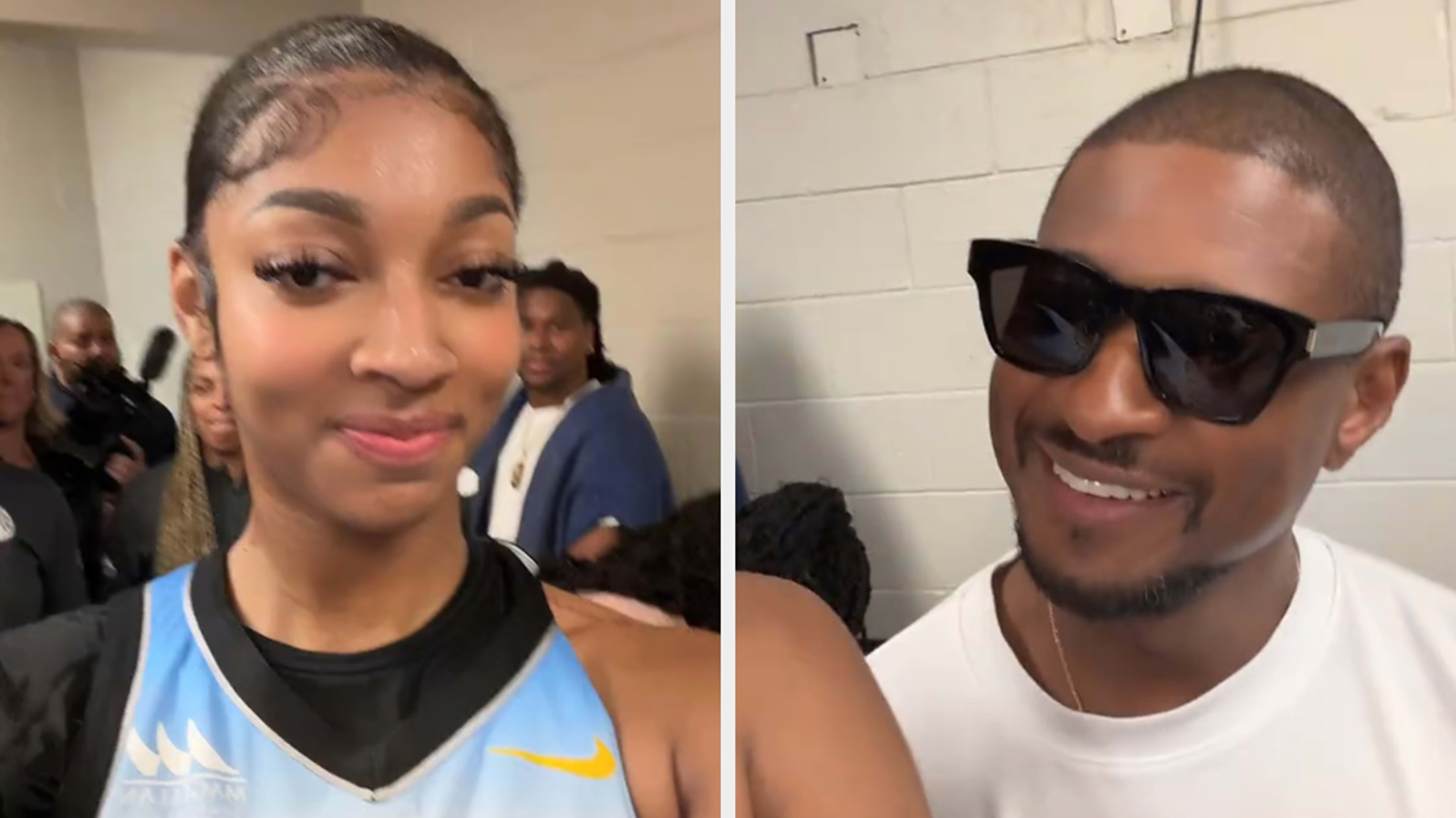 Usher sitting courtside at a basketball game and posing with fans, wearing a white T-shirt, black pants, and sunglasses