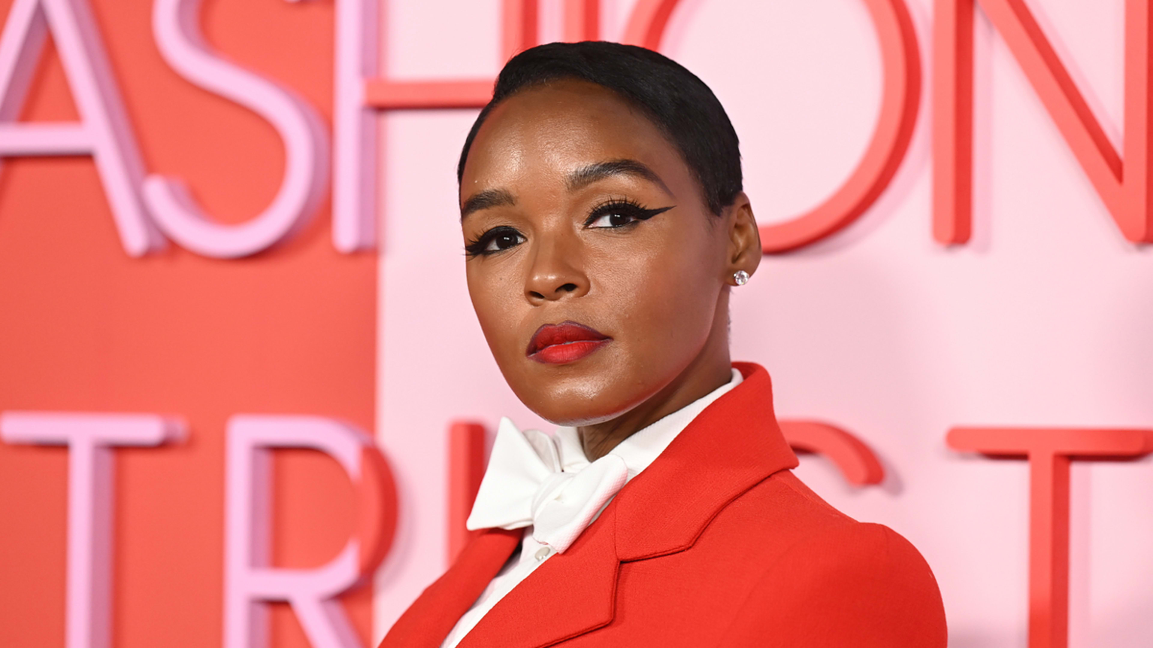 Woman in a stylish red blazer and white top poses at an event