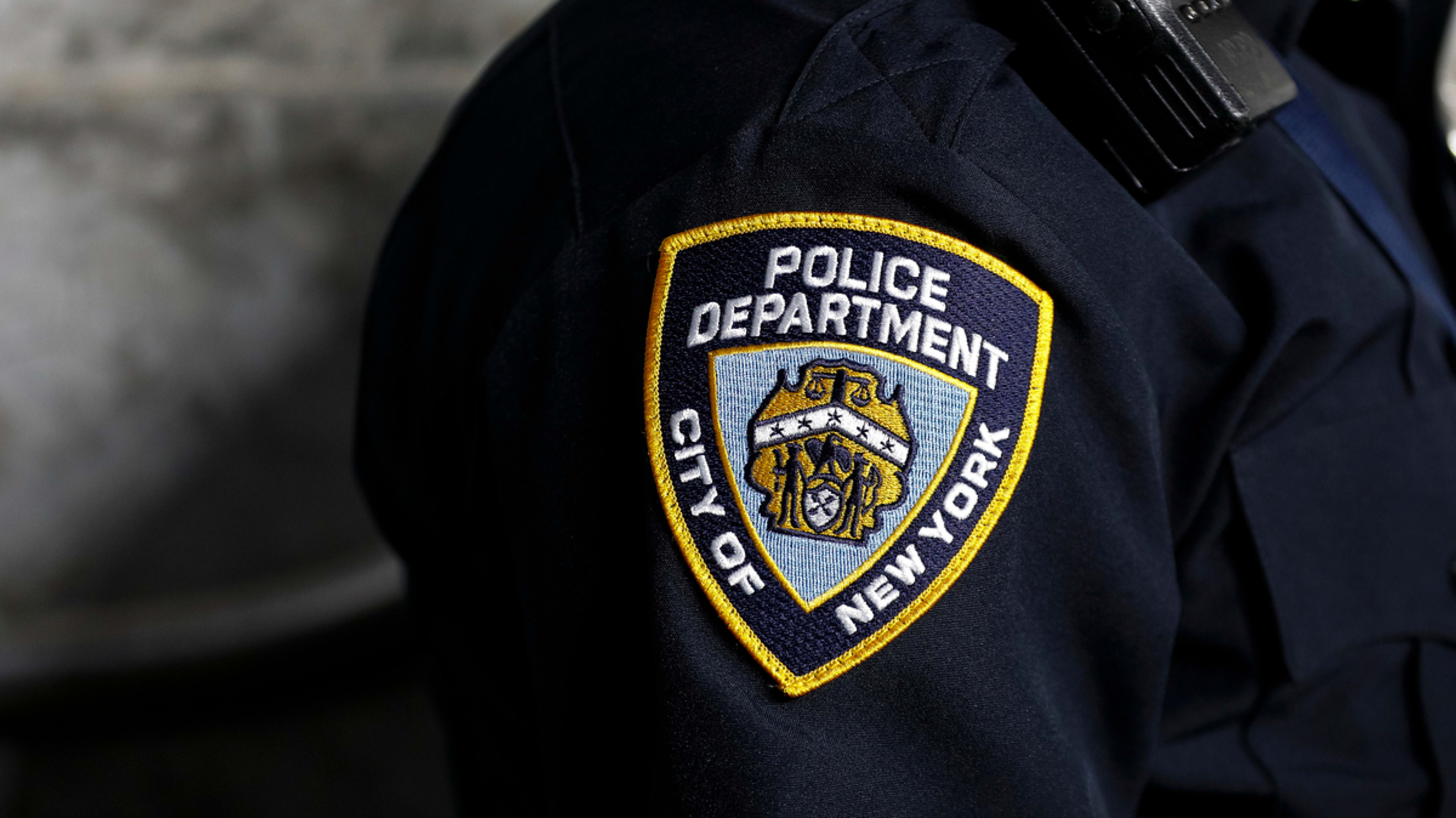 Close-up of an NYPD uniform shoulder patch on an officer, representing law enforcement in New York City