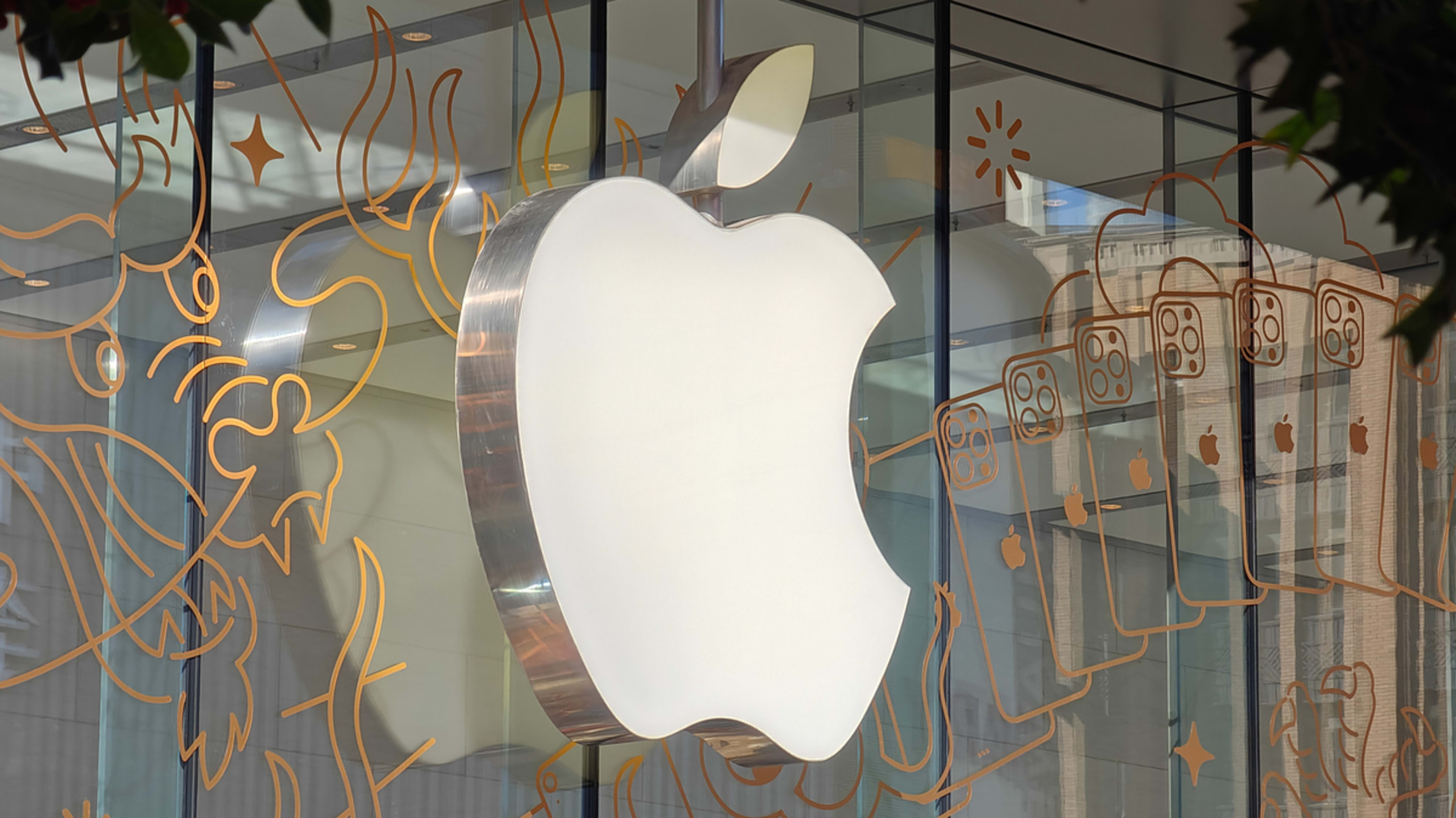 Apple logo on a store facade with artistic line patterns in the background