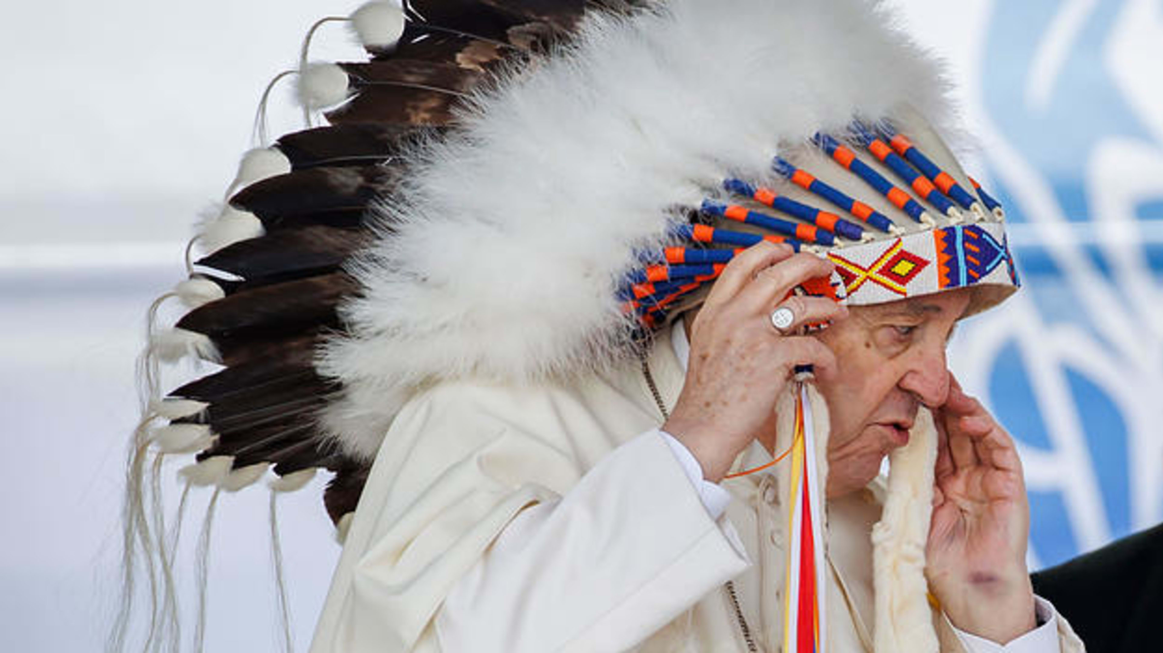 Pope Francis wears a traditional headdress that was gifted to him following his apology during his visit to Maskwacis, Canada